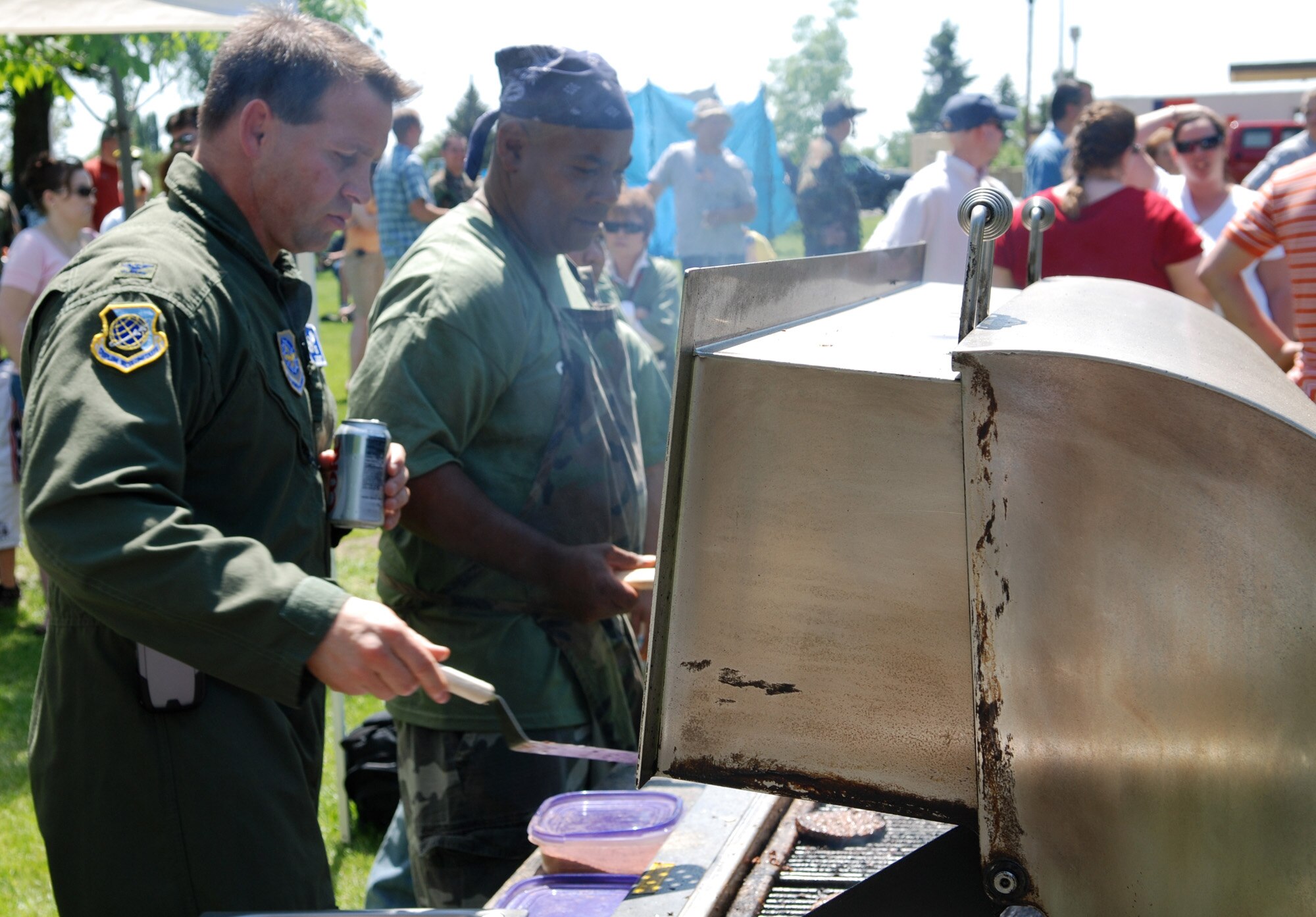 FAIRCHILD AIR FORCE BASE, Wash. -- Colonel Thomas Sharpy, 92nd Air Refueling Wing commander, and Chief Master Sgt. Tony Cameron, 92nd Mission Support Group superintendent, grill hamburgers and hotdogs for the Team Fairchild members who were able to attend the WING MatchUP picnic June 1. (U.S. Air Force photo/ Tech. Sgt. Larry Carpenter)