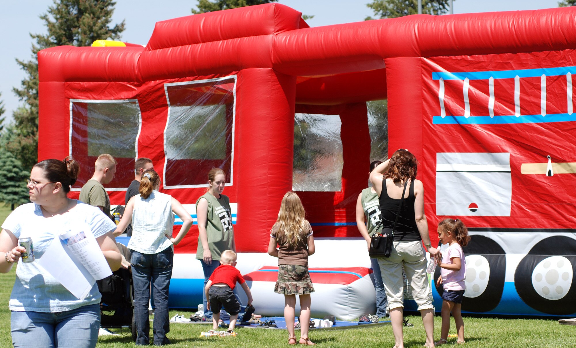 FAIRCHILD AIR FORCE BASE, Wash. -- Parents, children and picnic volunteers explore the blown-up fire engine at the Wing MatchUP picnic June 1. The fire engine was one of many exhibits for the picnic participants to explore. (U.S. Air Force photo/ Tech. Sgt. Larry Carpenter)