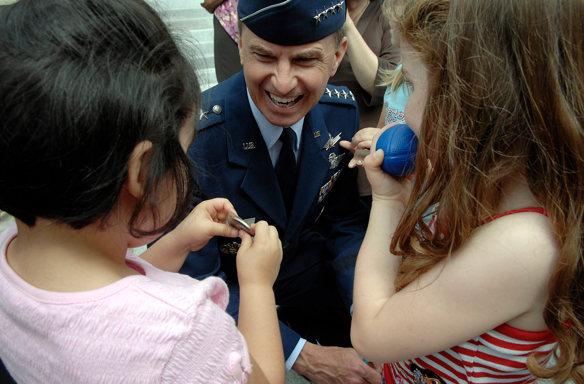 Gen. Kevin P. Chilton talks with Christina, 4, (left) and Isabella, 5, after the Air Force Week California Proclamation Ceremony June 4 at Sacramento, Calif. The purpose of Air Force Week is to inform and educate the American public about the importance and roles of the Air Force in America's national defense. Christina and Isabella were visiting from nearby East End Child Care Center. General Chilton is the commander of the Air Force Space Command at Peterson Air Force Base, Colo. (U.S. Air Force photo/Tech. Sgt. Larry A. Simmons)