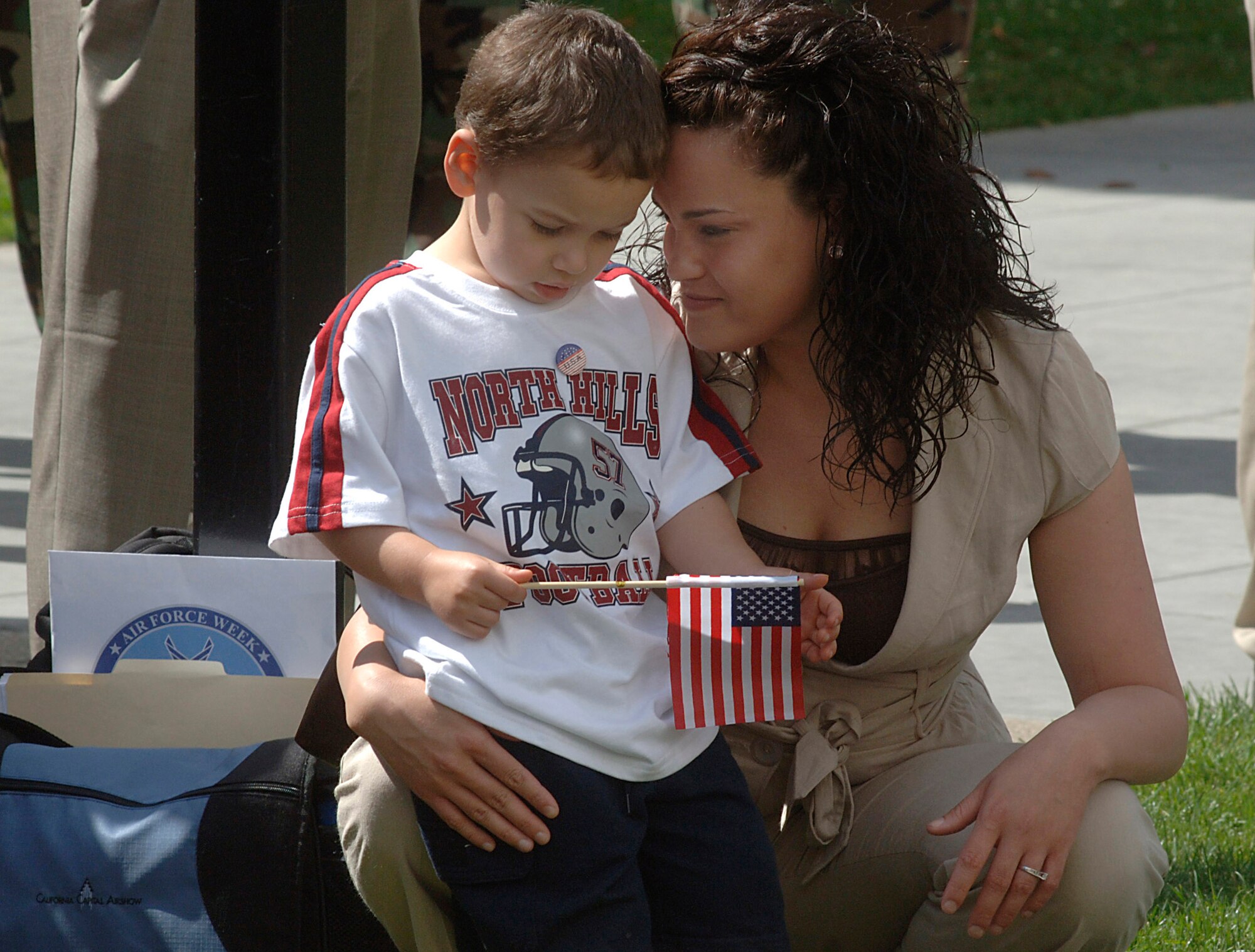 Amy Young hugs her son Noah, 4, during the Air Force Week California Proclamation Ceremony June 4 at Sacramento, Calif. His father is currently deployed to Iraq. The purpose of Air Force Week is to inform and educate the American public about the importance and roles of the Air Force in America's national defense. (U.S. Air Force photo/Tech. Sgt. Larry A. Simmons)
