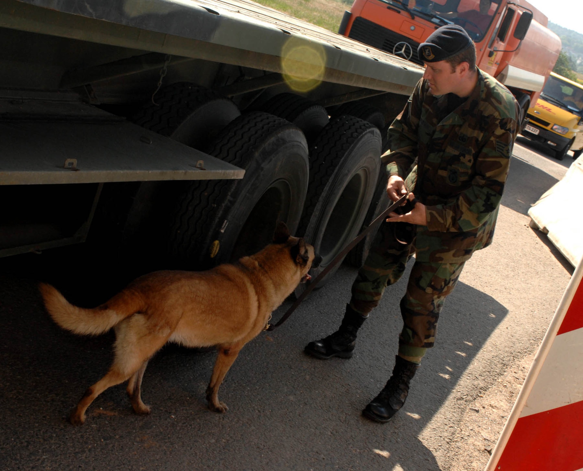 SPANGDAHLEM AIR BASE, GERMANY -- Staff Sgt. Eric Brown, 52nd Security Forces military working dog handler, searches a contracting vehicle with Laika his Belgian Malinois MWD here May 22, 2007. (U.S. Air Force photo/Airman 1st Class Stephanie Clark) 