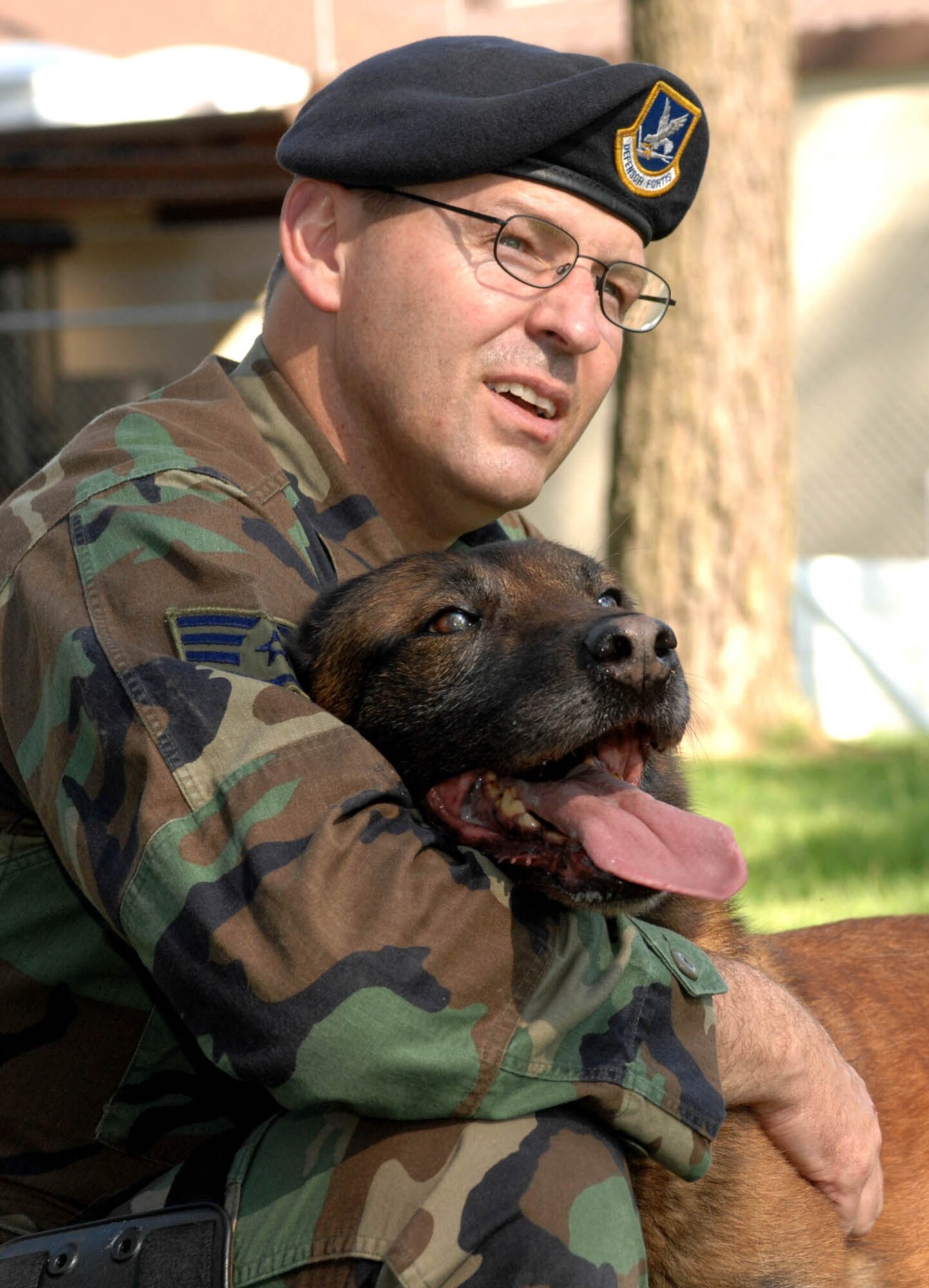 SPANGDAHLEM AIR BASE, GERMANY -- Staff Sgt. Keith Combass, 52nd Security Forces military working dog handler, shows affection to Carlo, a Belgian Malinois MWD, here May 22, 2007. Carlo was one of the first MWD deployed to Iraq in support of Operation Iraqi Freedom. (U.S. Air Force photo/Airman 1st Class Stephanie Clark) 