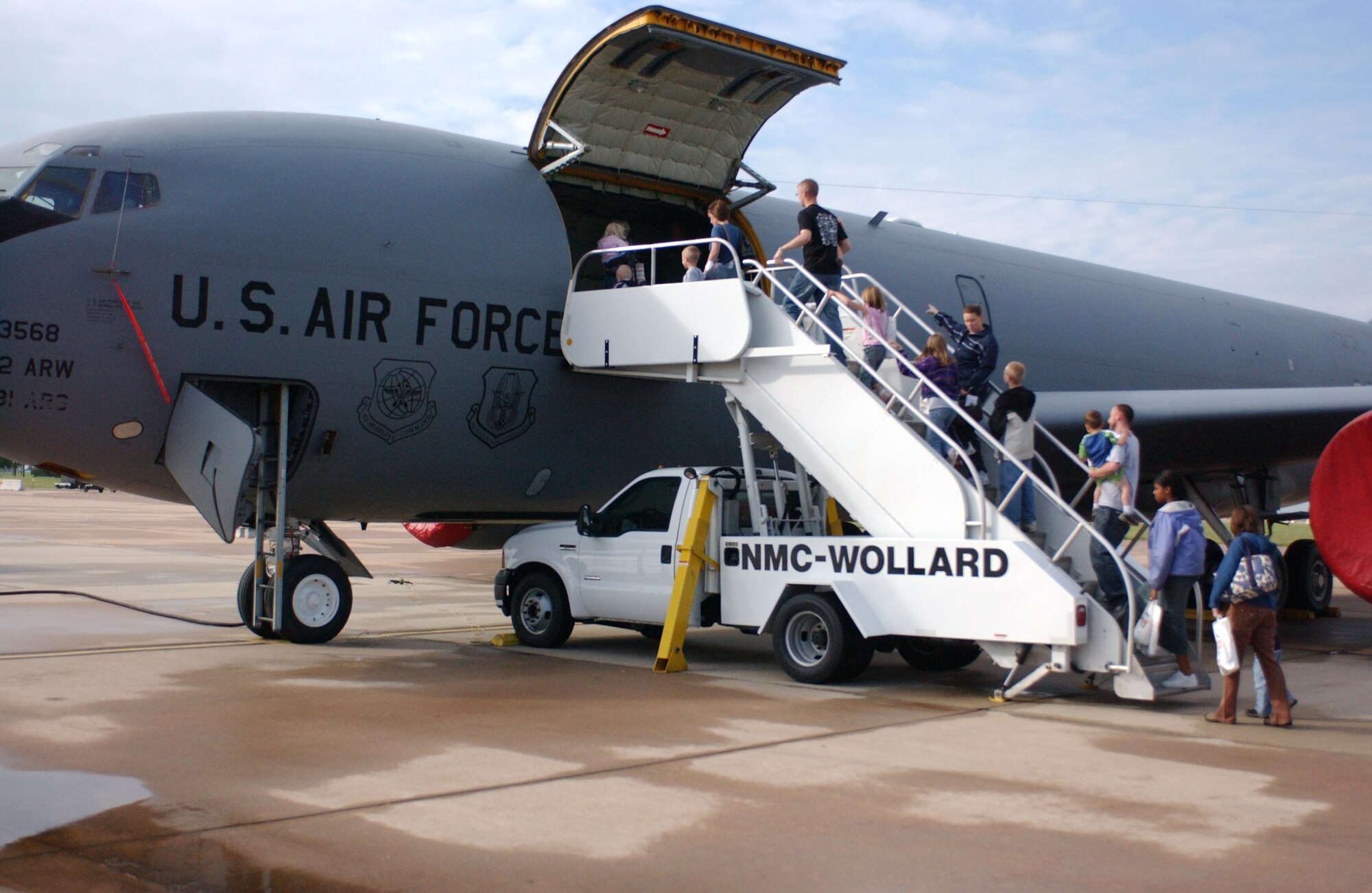 Families participating in Operation Deploying Family board a KC-135 Stratotanker after walking a deployment line as part of their simulated family deployment exercise here. (U.S. Air Force photo/Senior Airman Aldric Borders)
