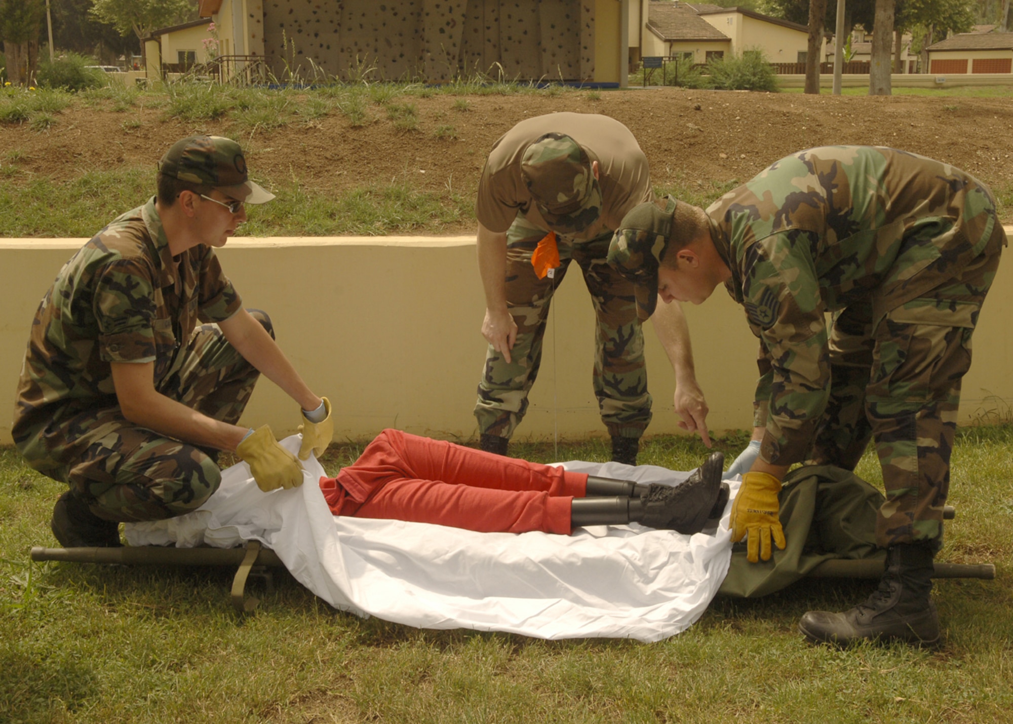 Staff Sergeant Liam Gannon, 39th Services Squadron non-commissioned officer in charge of readiness instructs Staff Sgt. Nicholas Evans, 39th Maintenance Squadron and Airman 1st Class Gregory Cain, 39th Communications Squadron, how to do the recovery process during the Search and Recovery Training May 31. The training helps Airmen know what to expect and what needs to be done in case there was a real world search and recovery event. (U.S. Air Force photo by Airman 1st Class Tiffany Colburn) (RELEASED)                                 