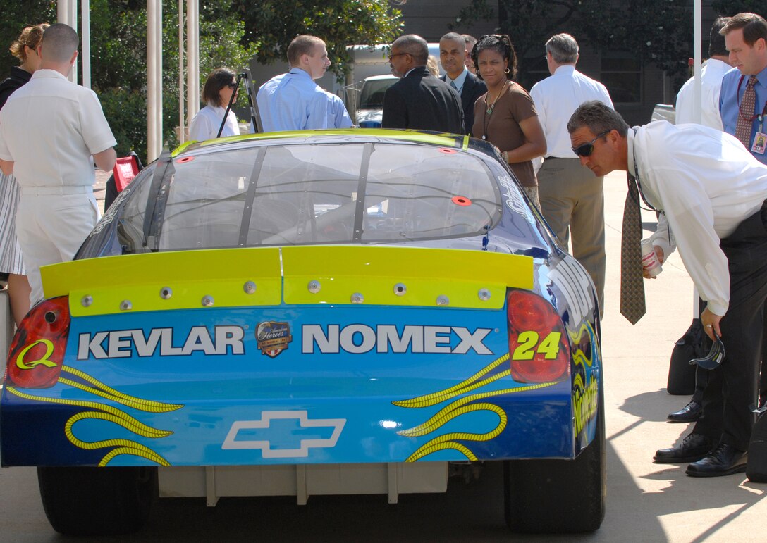 Civilians and servicemembers at the Pentagon examine a replica of the DuPont NASCAR vehicle driven by Jeff Gordon, on display in the courtyard of the Pentagon, June 5, 2007. The car has an America Supports You logo on the hood to show the company's support of U.S. men and women in uniform. Defense Dept. photo by U.S. Navy Petty Officer 2nd Class Molly A. Burgess