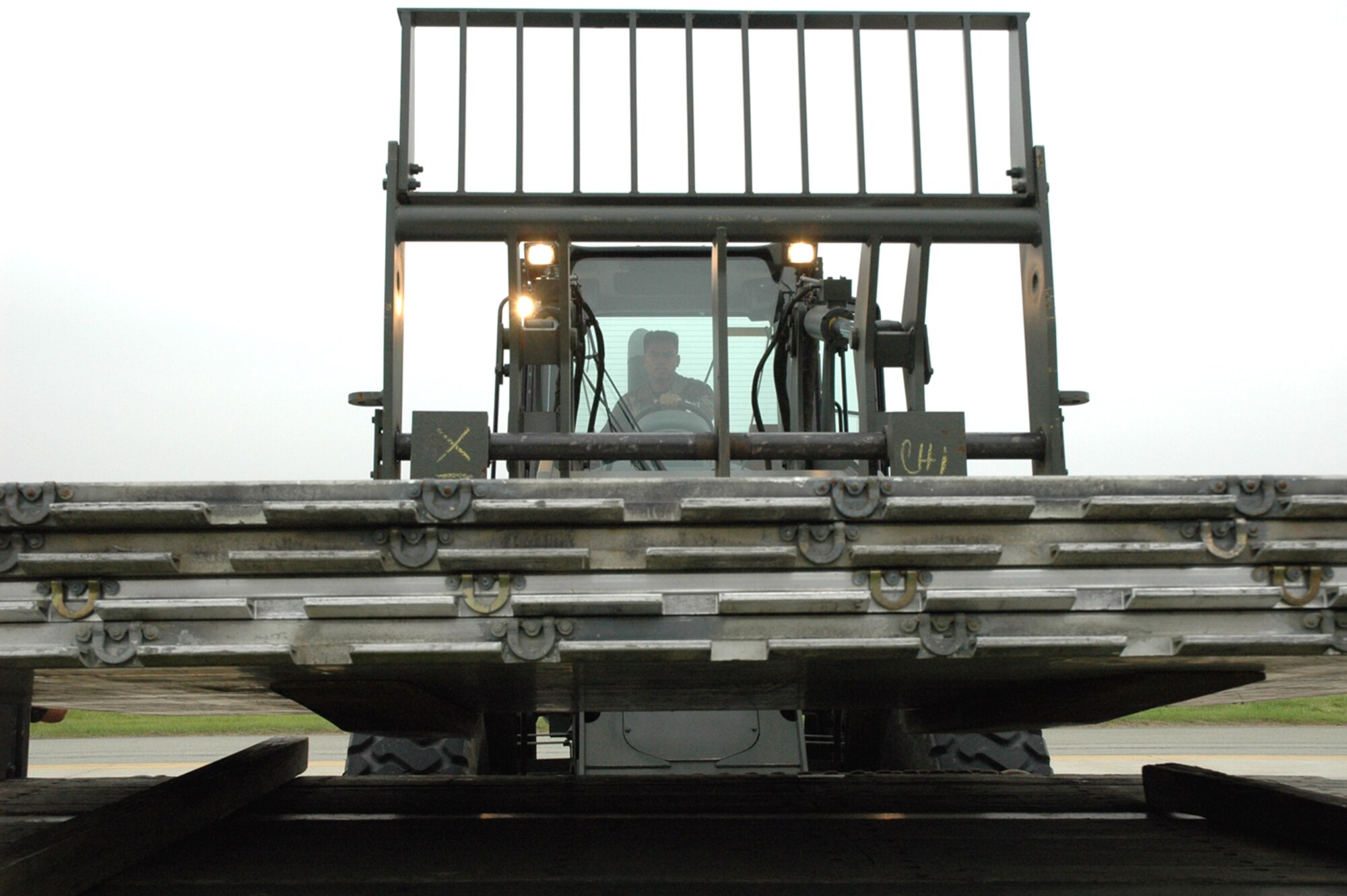 OSAN AIR BASE, Republic of Korea --  Airman 1st Class Rudy Garcia, 51st Logistics Readiness Squadron, unloads supplies for the 36th Fighter Squadron here Tuesday. Logistics readiness Airmen transported supplies and personnel around the peninsula before, during and after the recent runway renovation. (U.S. Air Force photo by Staff Sgt. Benjamin Rojek)