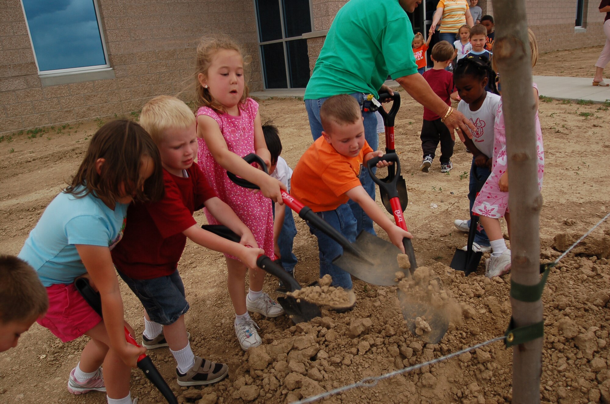 BUCKLEY AIR FORCE BASE, Colo. -- Claudia Sandifur, Braden Stauffer, Anatolia Russo and Aidon Bender help plant a tree June 6 to celebrate Buckley's Arbor Day. The National Arbor Day Foundation awarded Buckley its third Tree City USA Award during the ceremony. Buckley qualified for the award for having a tree board and a tree ordinance, spending at least $2 for every person at Buckley on trees and maintenance and having an Arbor Day observance and proclamation. (U.S. Air Force photo by Senior Airman Jacque Lickteig)