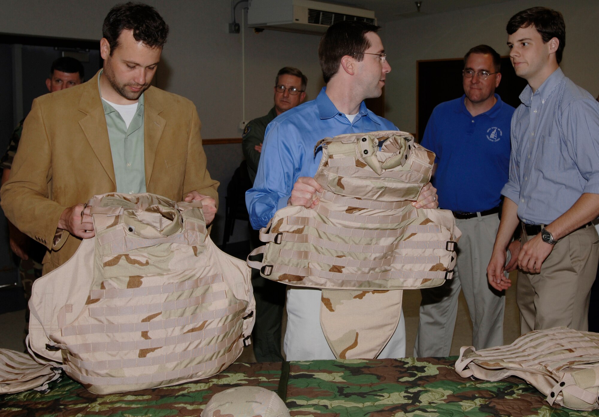 Jim Richardson, military legislative assistant for U.S. Representative Todd Tiahrt; Chris Alsup, military legislative assistant for U.S. Representative John Carter; David Brown, military legislative correspondent for Senator Mel Martinez; and Maj. Craig Harding, Secretary of the Air Force/Financial Management Leader observe combat protection gear during a base tour May 29. The representatives visited to gain understanding of the 22nd Air Refueling Wing’s mission and daily operations. (Photo by Senior Airman Jamie Train)