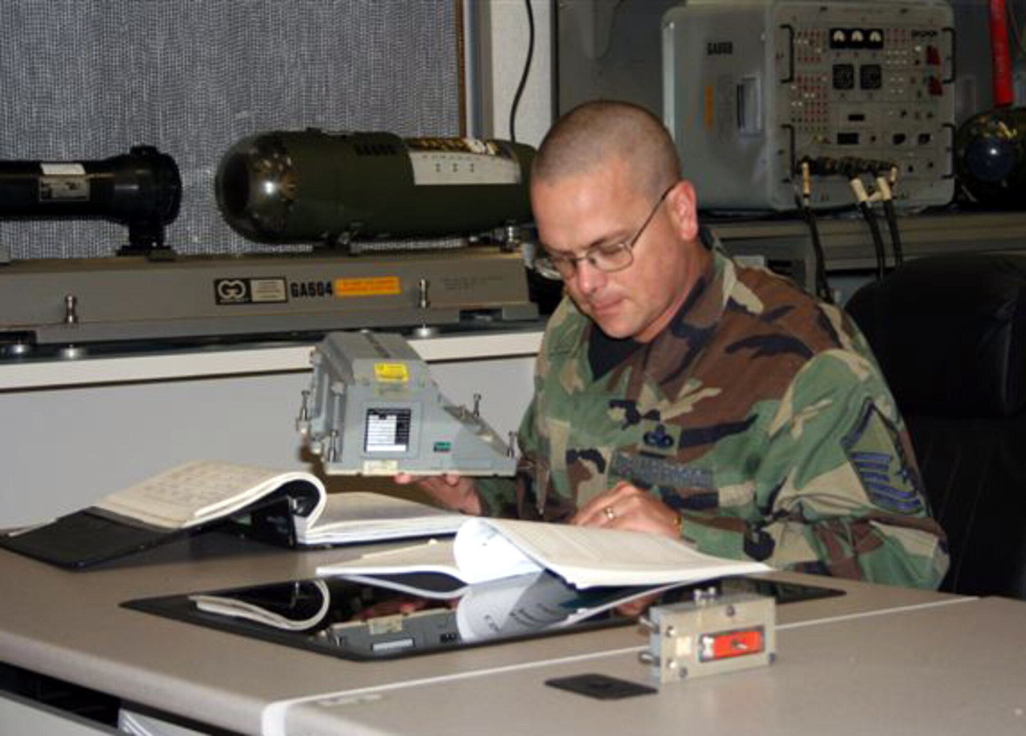 Master Sgt. Theodore Heiman, an avionics sensor systems career development course writer assigned to the 365th Training Squadron, reviews technical orders and CDC materials as part of a production tasking. Sergeant Heiman was selected to attend the Air Force Institute of Technology. (U.S. Air Force photo)