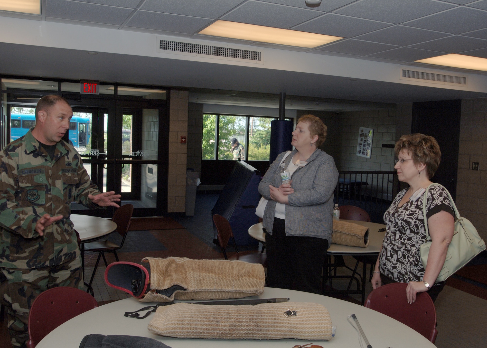 Tech. Sgt. Mike Laughlin, 319th Security Forces Squadron, explains equipment used during a K-9 demonstration to Gail Christopher (left) and Tammy Christenson (right) from the Golden Eagles Club here June 1. The Golden Eagles Club was formed in 1990 and is a division of the Chamber’s Military Appreciation Committee. (U.S. Air Force photo/Staff Sgt. Suellyn Nuckolls)