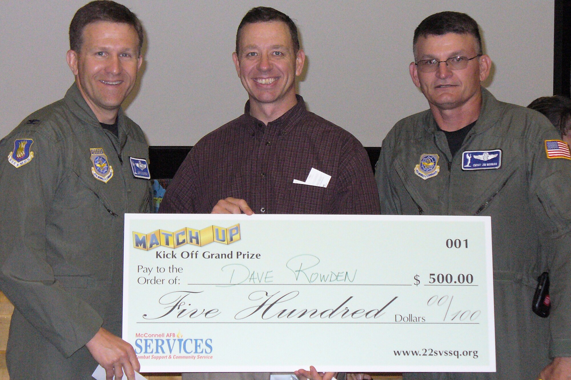 David Rowden, 22nd Operations Group; holds a check for $500 from the MatchUP kick-off June 1. The check was presented by Colonel John Zazworsky, 22nd Air Refueling Wing vice commander (far left) and Chief Master Sgt. James Mormon 22nd Operations Group (far right). (Courtesy photo)