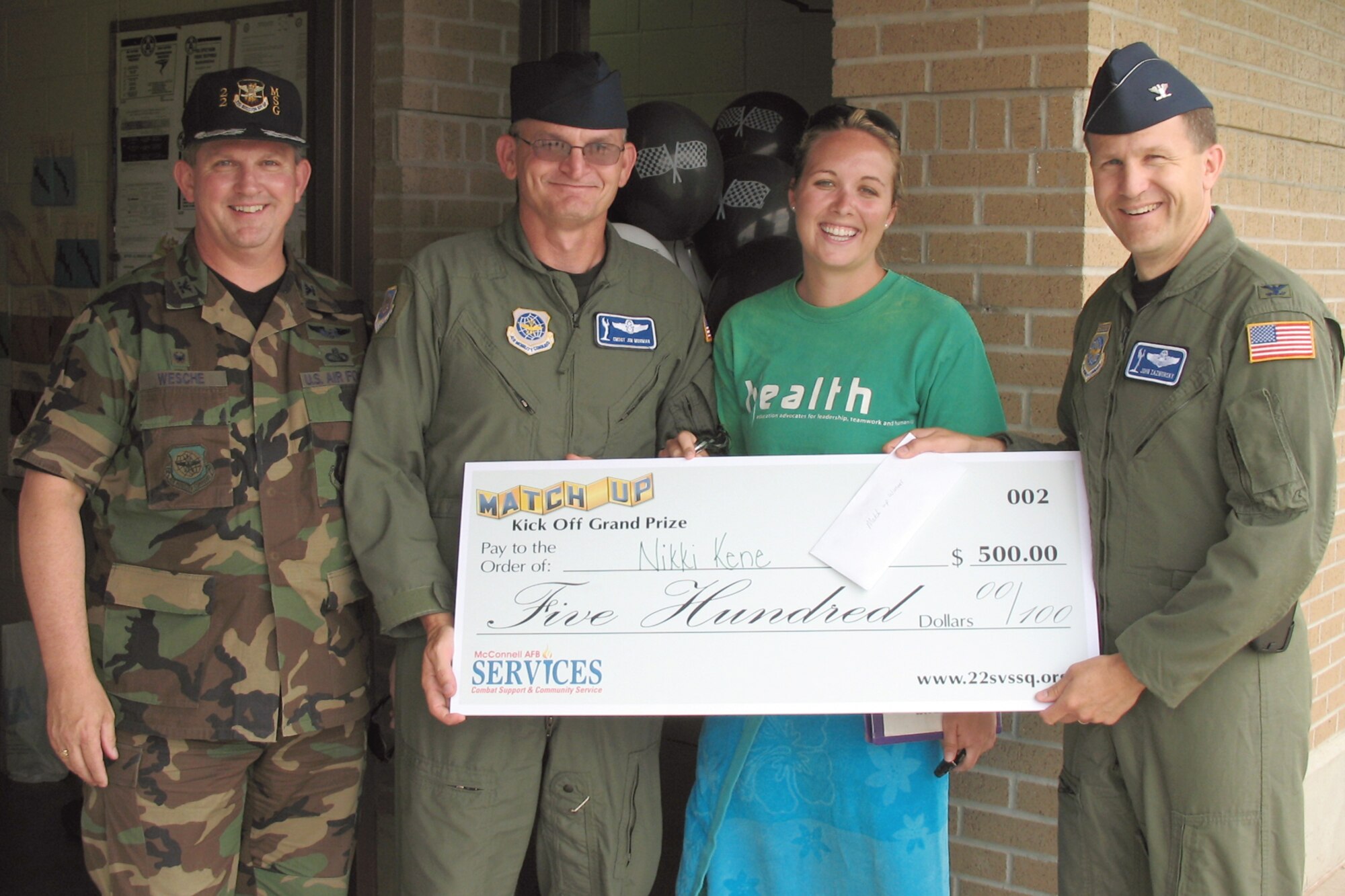 Colonel Richard Wesche, 22nd Mission Support Group commander (far left); Chief Master Sgt. James Morman, 22nd Operations Group and Colonel John Zazworsky, 22nd Air Refueling Wing vice commander (far right); surprise winner; Nikki Kene, 22nd Services Squadron lifeguard; with one of the two $500 cash prizes given away at the MatchUP kick-off June 1. (Courtesy photo) 