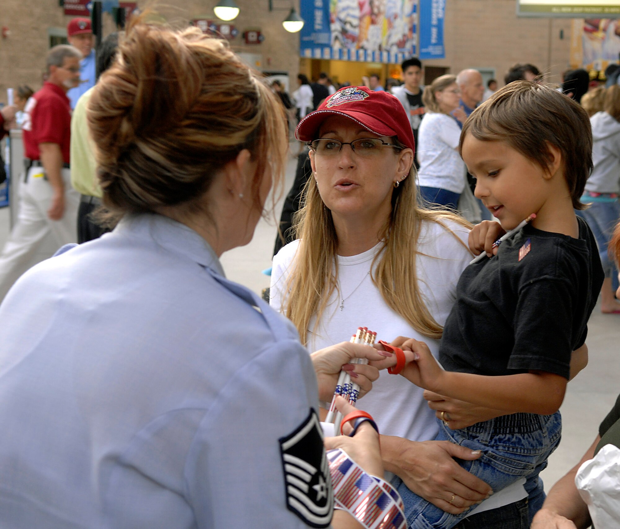 Master Sgt. Denise Fuentes talks to Sharon and Joseph Estrella about the oppurtunities available in the Air Force before a local minor league baseball game June 4 during Air Force Week in California. The purpose of Air Force Week is to inform and educate the American public about the importance and roles of the Air Force in America's national defense. Sergeant Fuentes is a recruiter for the Sacramento Air National Guard. (U.S. Air Force photo/Tech. Sgt. Larry A. Simmons)