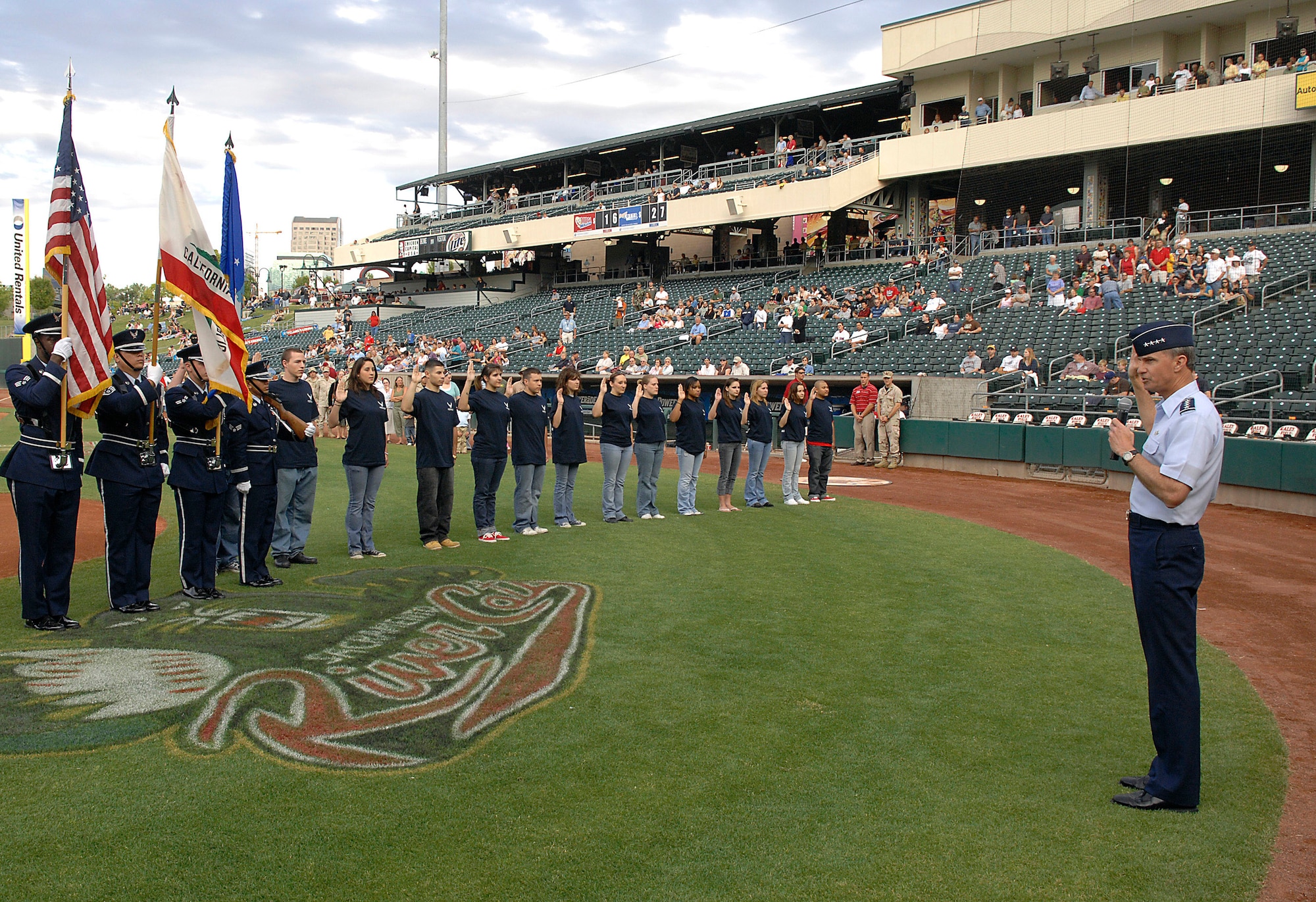 Gen. Kevin P. Chilton enlists several teenagers into the delayed enlistment program before a local minor league baseball game June 4 during Air Force Week in California. The purpose of Air Force Week is to inform and educate the American public about the importance and roles of the Air Force in America's national defense. General Chilton is the commander of the Air Force Space Command at Peterson Air Force Base, Colo. (U.S. Air Force photo/Tech. Sgt. Larry A. Simmons)

