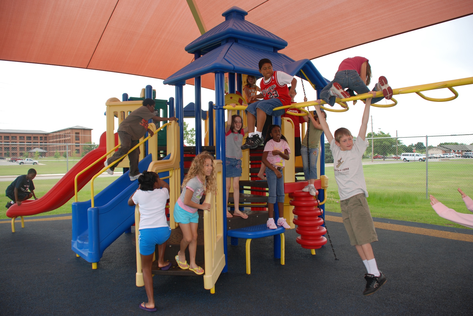 Children attending the Madrigal Youth Center's summer camp play outside on the playground June 4. (U.S. Air Force photo/Airman 1st Class Jacob Corbin)