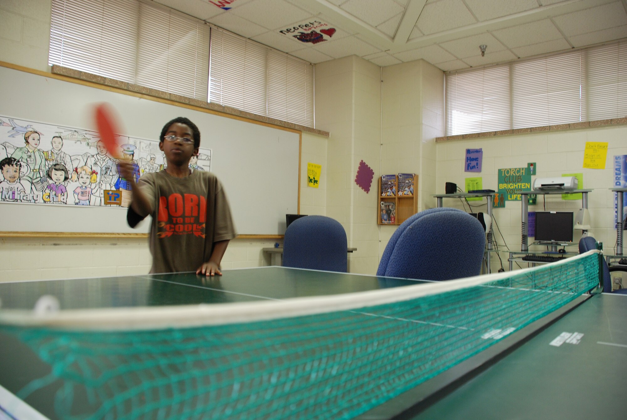 Doug Carroll plays ping-pong at the Madrigal Youth Centers summer camp June 5. (U.S. Air Force photo/Airman 1st Class Jacob Corbin)