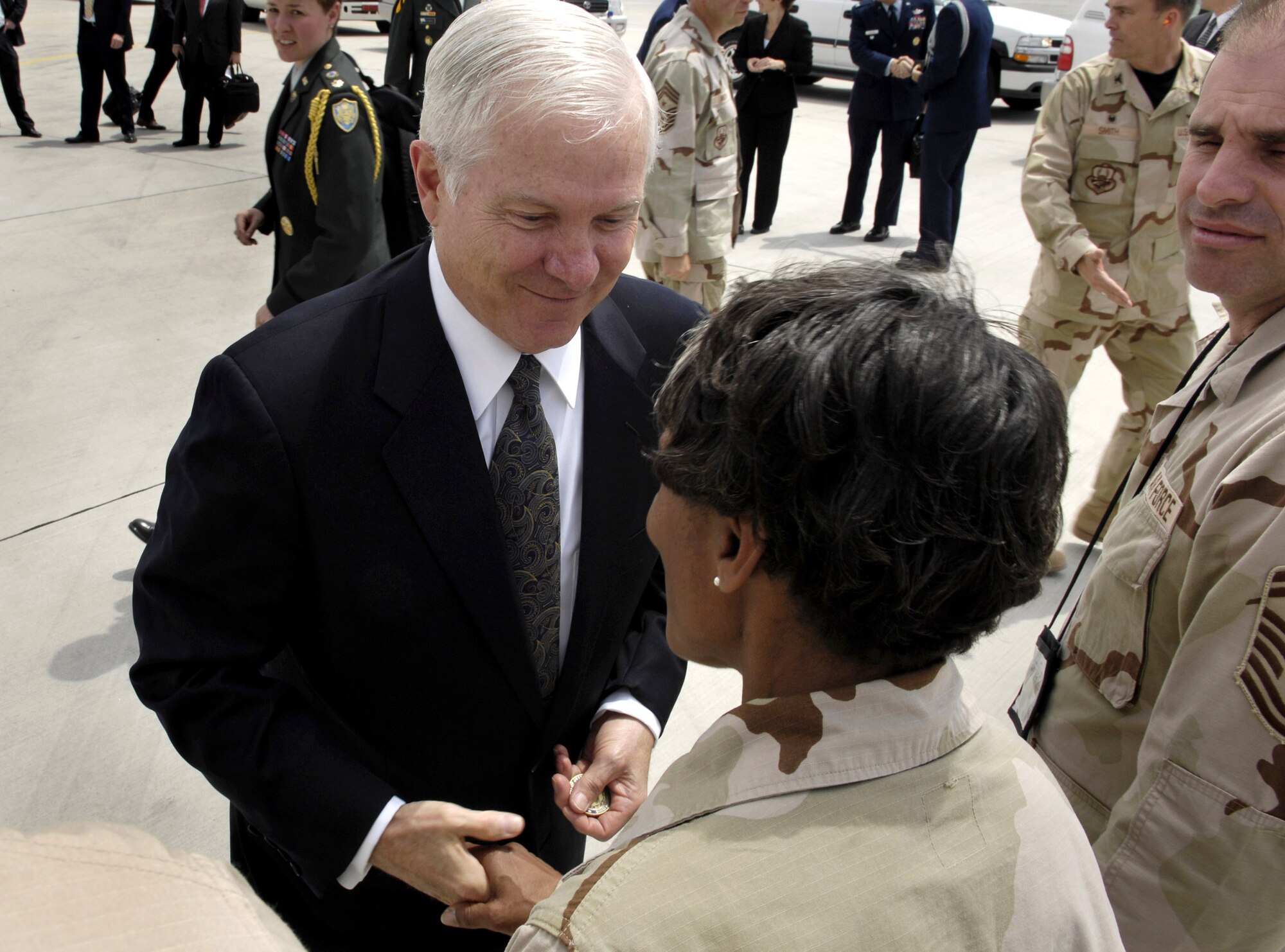 Secretary of Defense Robert M. Gates gives a coin to an Airman deployed to Manas Air Base, Kyrgyzstan, June 5. During his travels, he used the opportunity to hear directly from the troops about their concerns and to answer their questions.  (DOD photo/Cherie A. Thurlby)
