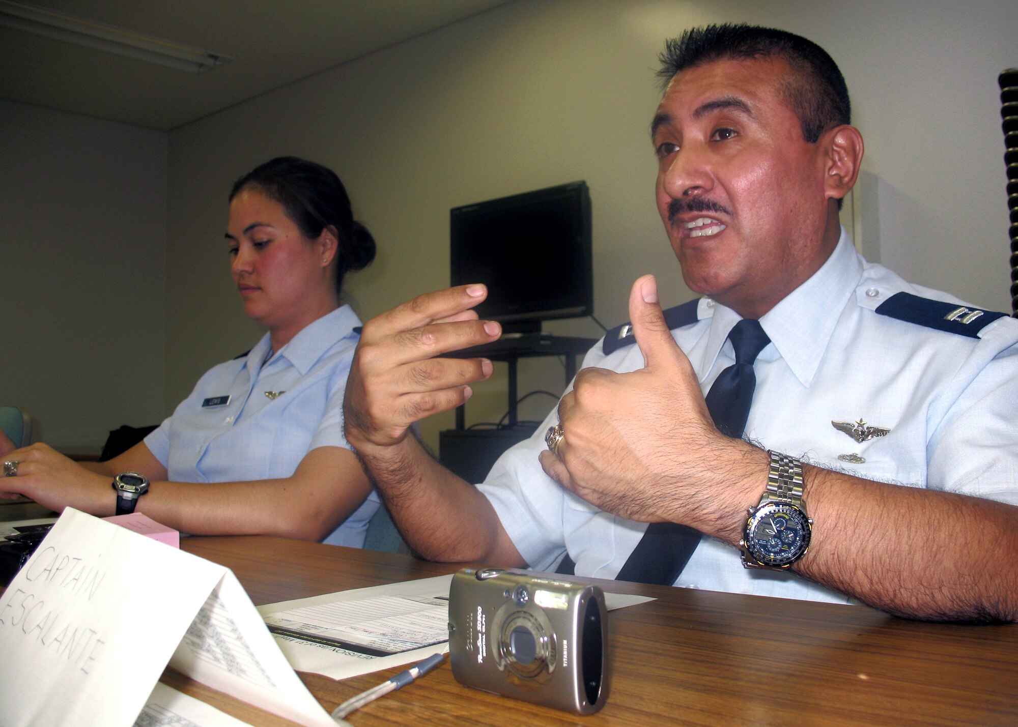 Capt. Miguel Escalante discusses life in the Air Force during a cultural exchange with Japanese officers at the Japan Air Self Defense Force's Meguro College. Captain Escalante and other Air Force officers took part in the exchange to help improve the English skills of JASDF officers attending the school.  Captain Escalante is a flight nurse with the 374th Medical Operations Squadron at Yokota Air Base, Japan.  (U.S. Air Force photo/Senior Airman David Clark)