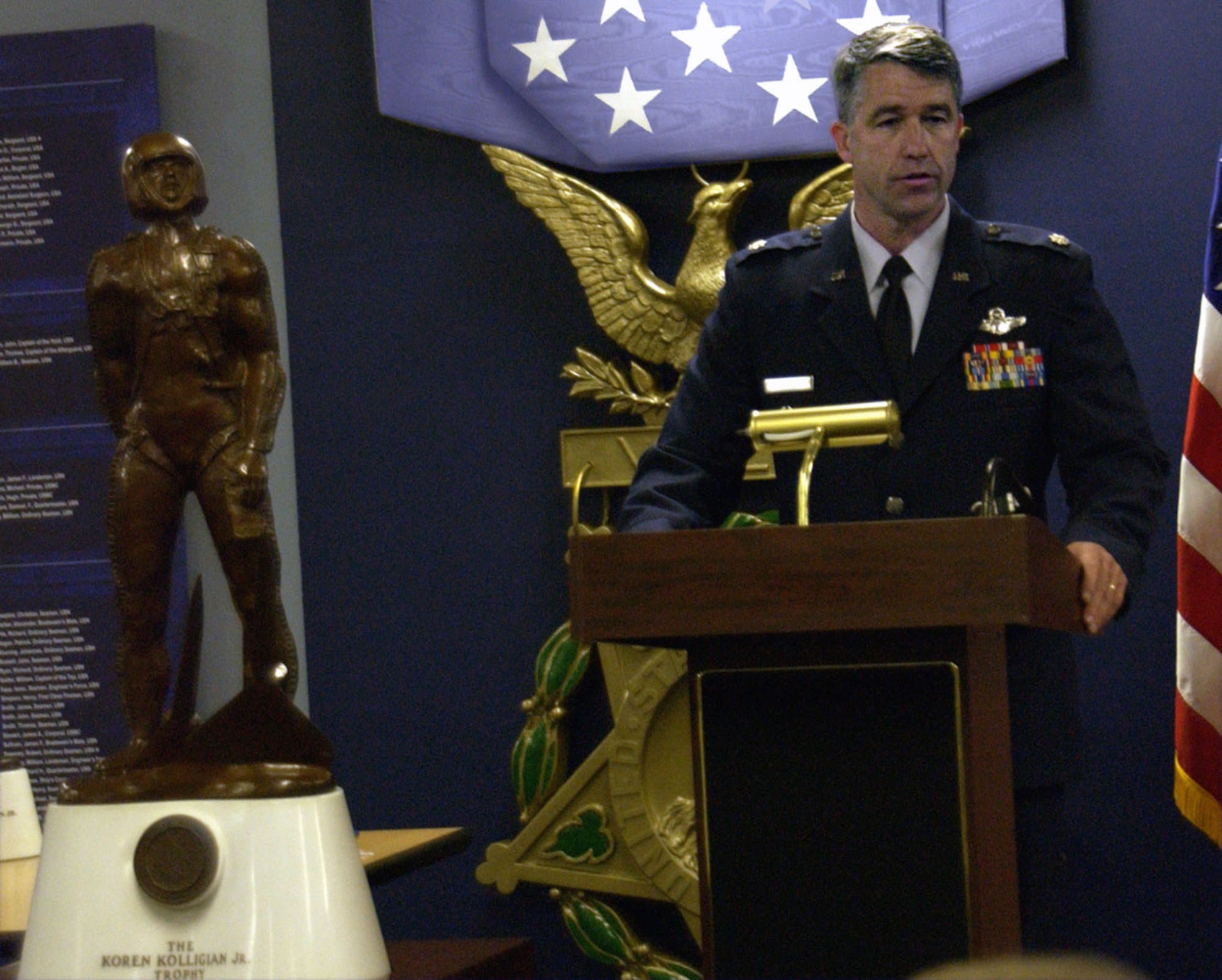 Lt. Col. Peter Byrne thanks his family, friends and coworkers during a ceremony June 5 at the Pentagon's Hall of Heroes. He was awarded the Koren Kolligian Jr. Trophy, which stands in the foreground. Colonel Byrne, the 140th Wing vice commander, earned the award from an incident in June 2006 when he suffered a stroke while flying an F-16 but was able to safely land the plane 90 minutes later.  (U.S. Air Force photo/Staff Sgt. J.G. Buzanowski)