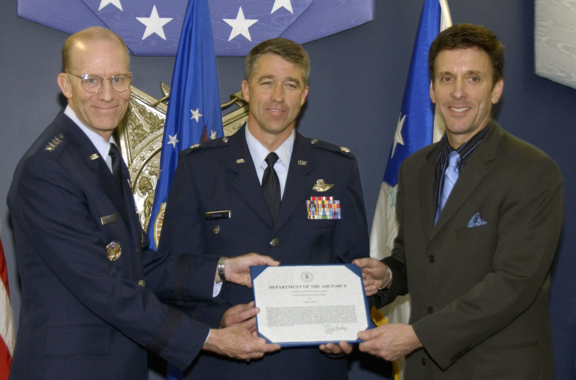 Air Force Vice Chief of Staff Gen. John D.W. Corley (left) and Koren Kolligian (right) present the Koren Kolligian Jr. Trophy to Lt. Col. Peter Byrne during a ceremony in the Pentagon June 5. The trophy, an Air Force safety award, is named after 1st Lt. Koren Kolligian Jr., whose T-33 Shooting Star went missing off the California coast in 1955.  The trophy is given annually to aircrew members who exhibit "outstanding feats of airmanship." Colonel Byrne, the 140th Wing vice commander, earned the award from an incident in June 2006 when he suffered a stroke while flying an F-16 but was able to safely land the plane 90 minutes later. Mr. Kolligian is the nephew of Lieutenant Kolligian. (U.S. Air Force photo/Staff Sgt. J.G. Buzanowski)
