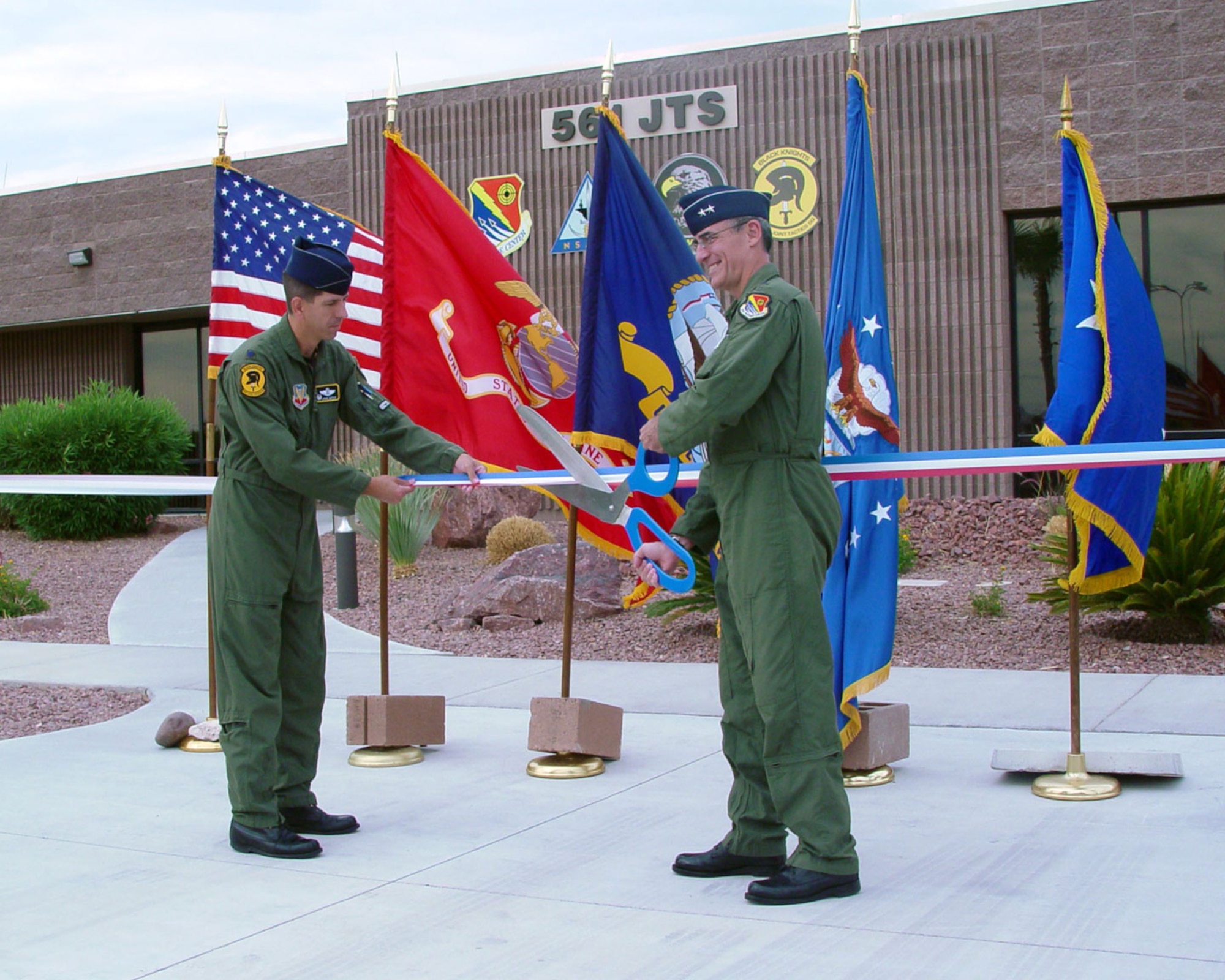 Maj. Gen. Mike Worden, U.S. Air Force Warfare Center commander, and Lt., Col. Louis Dupuis, 561st Joint Tactics Squadron commander, cut the ribbon officially reactivating the 561st JTS, June 5. After a decade of inactivity, the 561st JTS was reactivated as the single focal point for deployment-preparation training and capturing tactical lessons learned. (USAF Photo)
