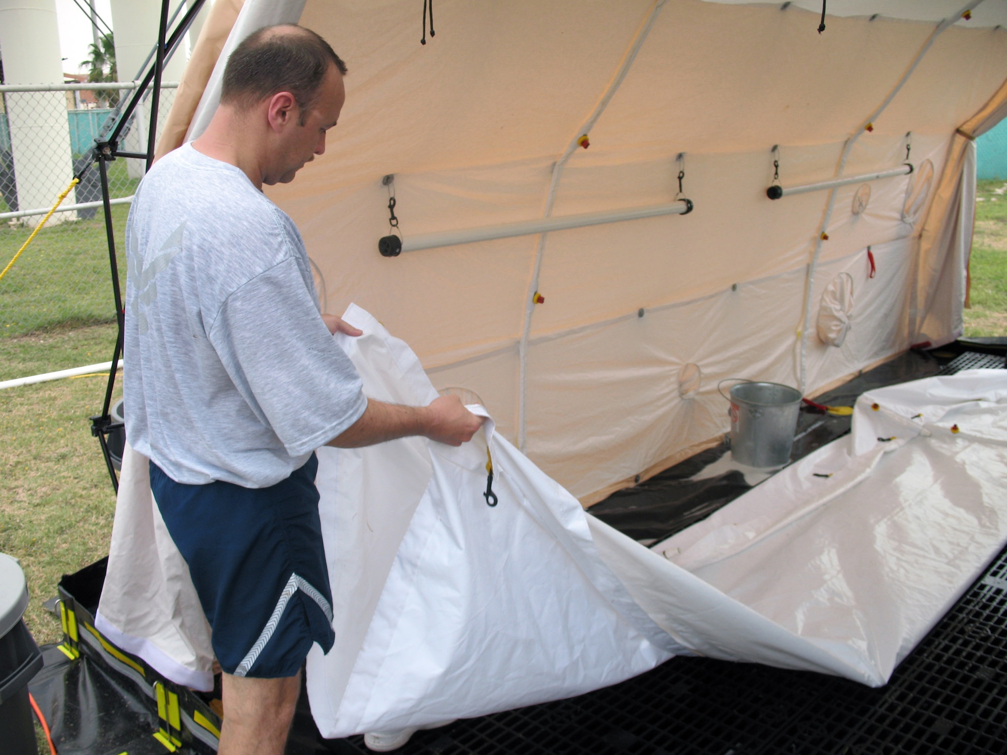 Master Sgt. Tim Allen helps set up the new in-place patient decontamination capability during an exercise May 31 at Incirlik Air Base, Turkey. The IPPDC allows Incirlik AB medics to decontaminate patients in the field during a chemical or biological attack. Sergeant Allen is the 39th Medical Group decontamination team chief. (U.S. Air Force photo/Staff Sgt. Michael Jackson)
