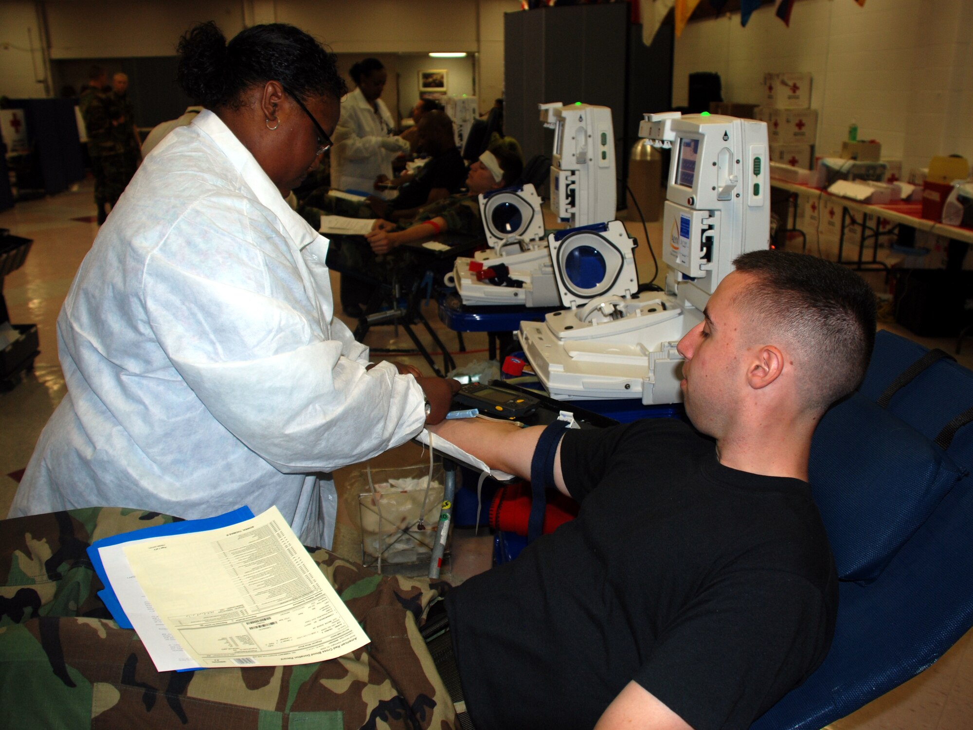 A phlebotomist with the Red Cross prepares Airman Basic Thomas Brown, an Airman-in-Training with the 365th Training Squadron, to give blood June 5 at the community activity center. (U.S. Air Force photo/Airman 1st Class Jacob Corbin)