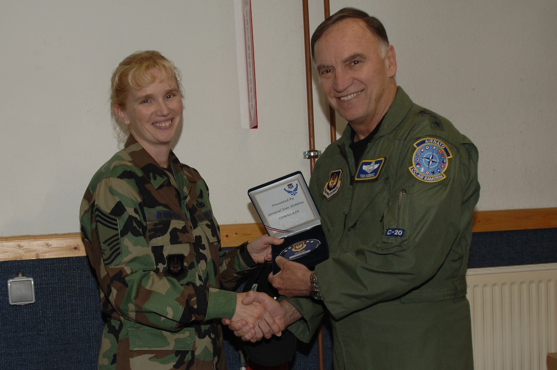 Chief Master Sgt. Eden Merrifield of the 435th Logistics Readiness Group at Ramstein Air Base, Germany, is presented the ACE Award by Gen. Tom Hobbins, Commander U.S. Air Forces in Europe. Chief Merrifield was recognized for her extensive support for the USAFE Annual Awards Banquet. The ACE Award consists of a large medallion engraved with the recipient's name and is sequentially numbered by order. (U.S. Air Force photo/Airman 1st Class Heidi Holston)
