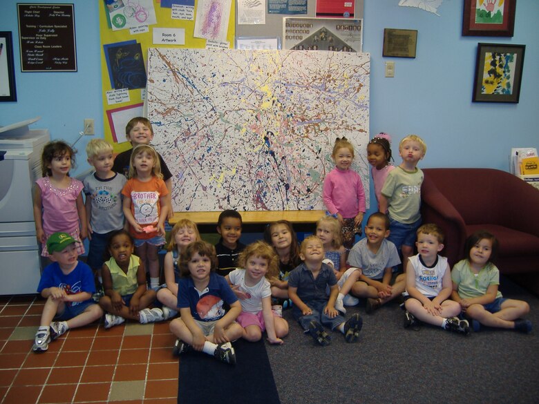 As part of their curriculum, the child development center has begun a study of famous artists. This week they looked at the art work of Jackson Pollock, known for his experimentation in painting techniques and his abstract style.  Lisa Kimmel, who teaches art at State Fair Community College, offered to help the children create a work of art using Pollock’s techniques. Lisa furnished a large canvas; children were given brushes and different colors of paint and created their own action spatter painting.  We encourage all parents to share special talents with our children. Lisa plans to enter the painting in the children’s exhibit at the Missouri State Fair this summer and, according to child development center director Judy Van Boening, will be featured in the new child development center when it opens. (Photo courtesy of 509th Services Squadron)