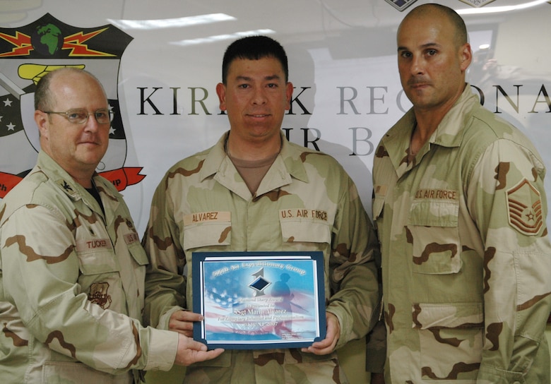 Staff Sgt. Mario Alvarez, 727th Expeditionary Air Control Squadron, receives the 506th Air Expeditionary Group Diamond Sharp Award June 4 from Col. Douglas Tucker, 506 AEG commander (left), and Master Sgt. Ty Jarry, 727 EACS first sergeant, at Kirkuk Regional Air Base, Iraq. Sergeant Alvarez, a Miami, Fla. native, is deployed from Hill Air Force Base, Utah.