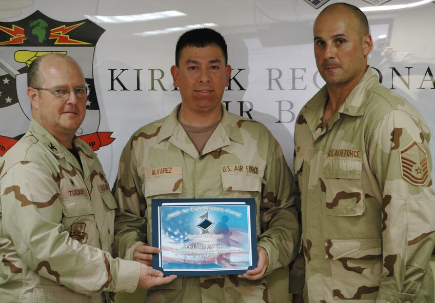 Staff Sgt. Mario Alvarez, 727th Expeditionary Air Control Squadron, receives the 506th Air Expeditionary Group Diamond Sharp Award June 4 from Col. Douglas Tucker, 506 AEG commander (left), and Master Sgt. Ty Jarry, 727 EACS first sergeant, at Kirkuk Regional Air Base, Iraq. Sergeant Alvarez, a Miami native, is deployed from Hill Air Force Base, Utah.