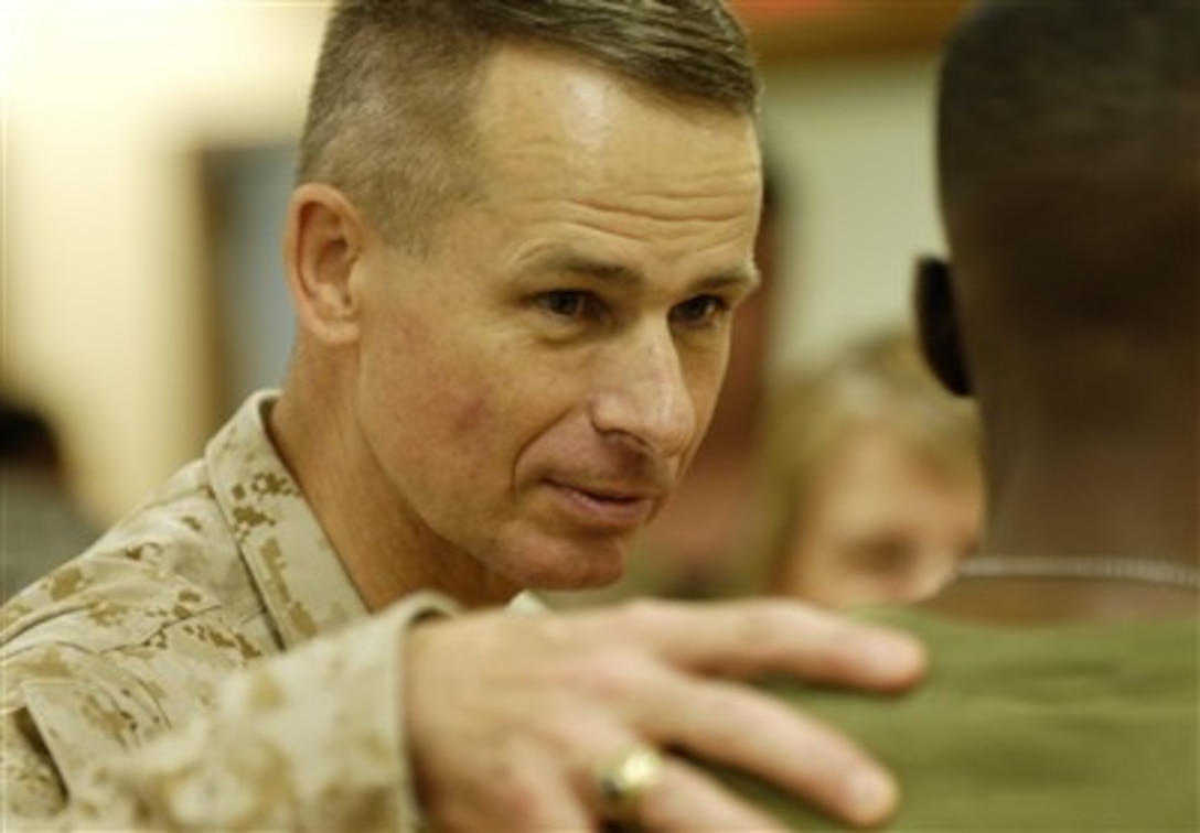 Chairman of the Joint Chiefs of Staff Gen. Peter Pace, U.S. Marine Corps, talks with a Marine that's rehabilitating his injured hand at Tripler Army Medical Center in Honolulu, Hawaii, on June 5, 2007.  Pace is visiting with recovering troops as he tours the Medical Center.  