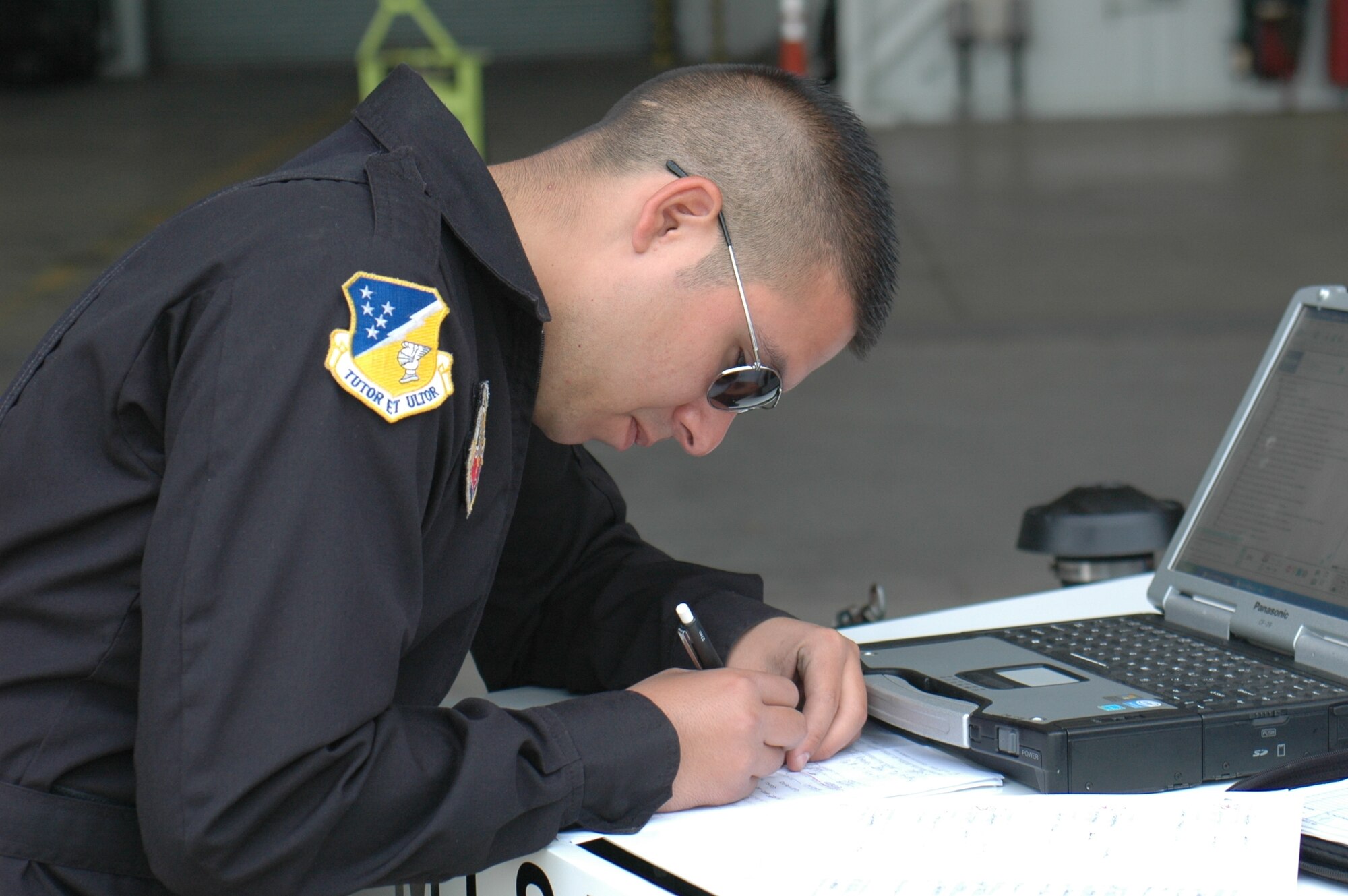 Staff Sgt. Oscar Vega, the avionics specialist for the F-117 Demo Team, fills out paperwork on one of the jets after a full day of air show activities. (U.S. Air Force photo by 1st Lt. Phillip Ventura)