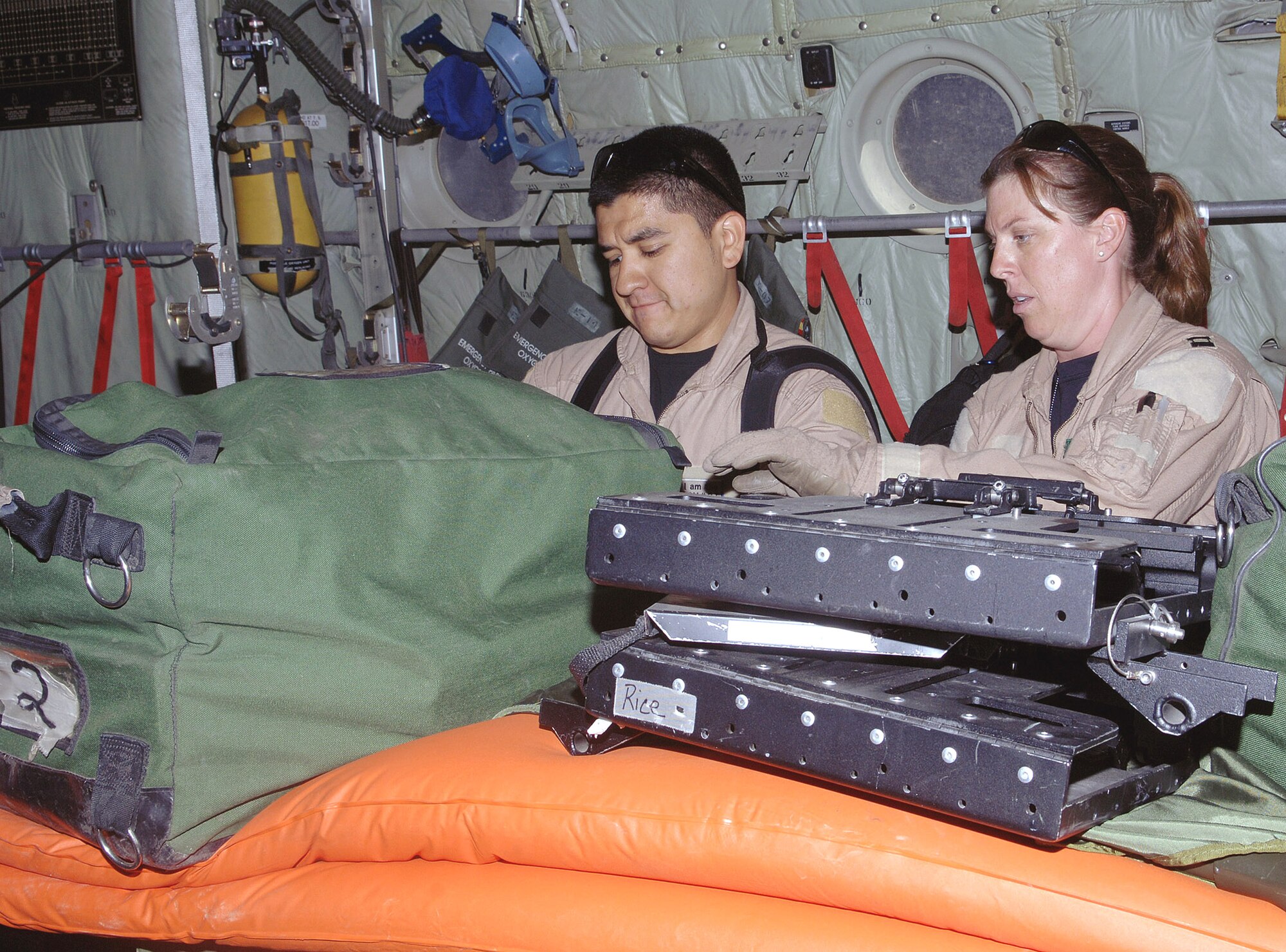 Senior Airman Roy Aguilar and Capt. Jenna Jamison inventory and prep their equipment aboard a C-130 Hercules at Bagram Air Base, Afghanistan, prior to an aeromedical evacuation mission.  Airman Aguilar is a respiratory therapist and Captain Jamison is an intensive care nurse.  They are deployed from Wilford Hall Medical Center, Lackland Air Force Base, Texas.  (U.S. Air Force photo/Staff Sgt. Craig Seals)