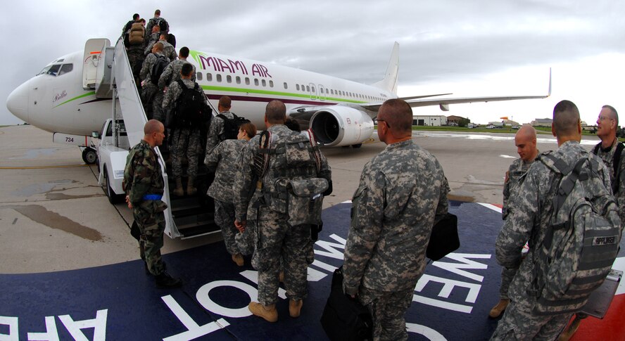 MINOT AIR FORCE BASE, N.D. – U.S. Air Force Lt. Col. Dan Semsel, 5th Logistics Readiness Squadron commander, says farewell to Soldiers from the North Dakota National Guard's 164th Engineer Battalion as they board a 737 aircraft on the flight line here.  More than 100 soldiers departed from Minot AFB en route to Camp Shelby Miss. prior to being deployed to a forward location in Iraq. The Soldiers will be deployed for approximately a year before returning to the U.S. (U.S. Air Force photo by Senior Airman Christopher Boitz)