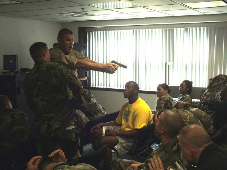 U.S. Air Force security forces students in the Phoenix Raven 06-F Course respond to an airplane highjacking scenario during classroom training for the course Aug. 1, 2006, in a U.S. Air Force Expedtionary Center classroom on Fort Dix, N.J.  The course, taught by the 421st Combat Training Squadron, trains security forces personnel in advanced techniques and training in areas such as use of force, anti-highjacking and aircraft security to name a few.  Tech. Sgt. Daniel Koenigsmann of the 421st CTS is role playing as the hijacker.  The Air Force Phoenix Raven Program recently celebrated its 10th anniversary in training having established in 1997. (U.S. Air Force Photo/Tech. Sgt. Scott T. Sturkol)