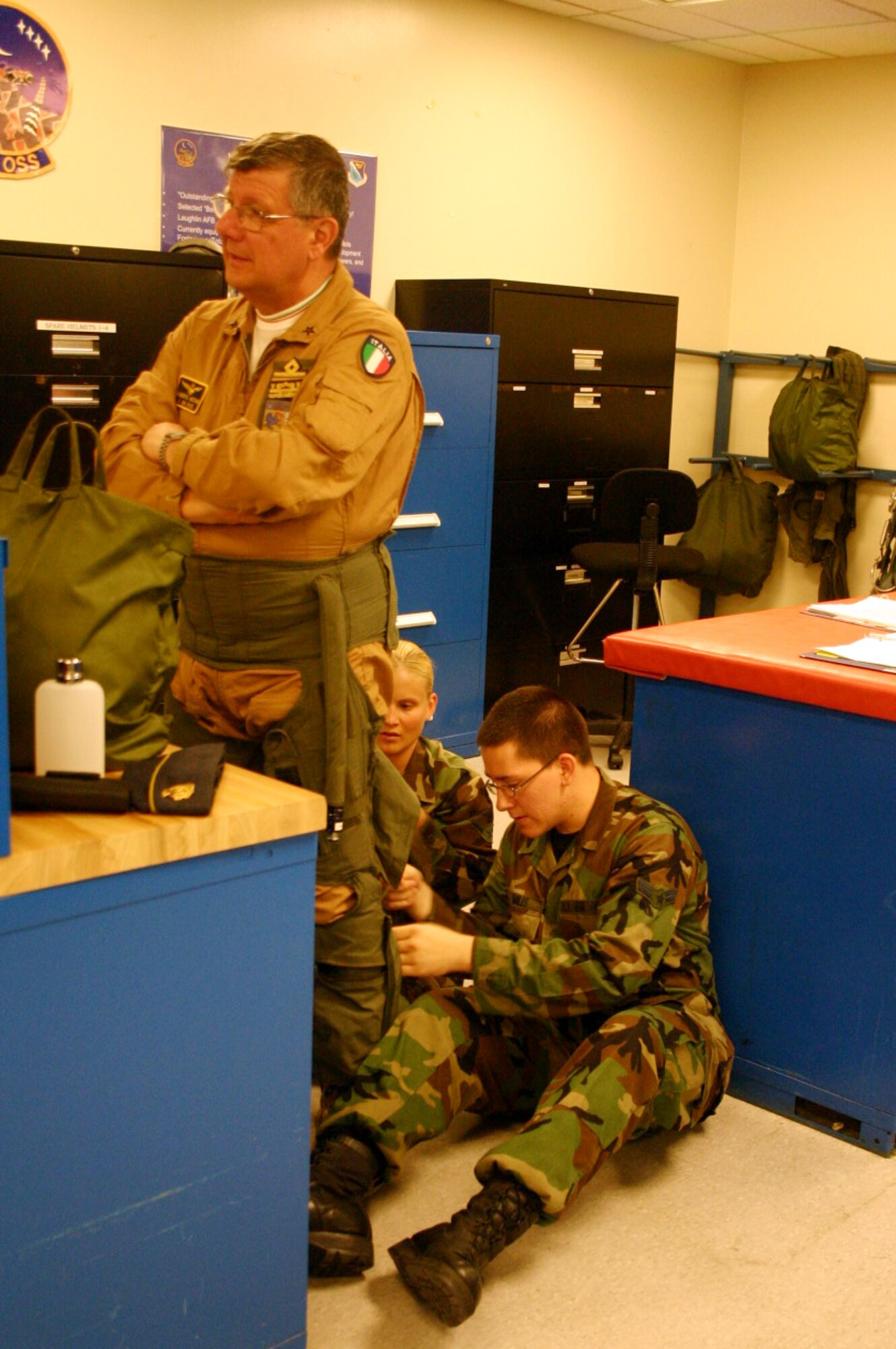 LAUGHLIN AIR FORCE BASE, Texas ? Airman Lindy Jo Hief and Airman 1st Class Christopher Miles, 47th Operations Support Squadron Life Support, prepare Italian Air Force Maj. Gen. Alberto Notari for a T-38 flight June 7.  General Notari visited Laughlin and addressed graduates of Specialized Undergraduate Pilot Training Class 07-10.(U.S. Air Force photo by Airman Sara Csurilla)