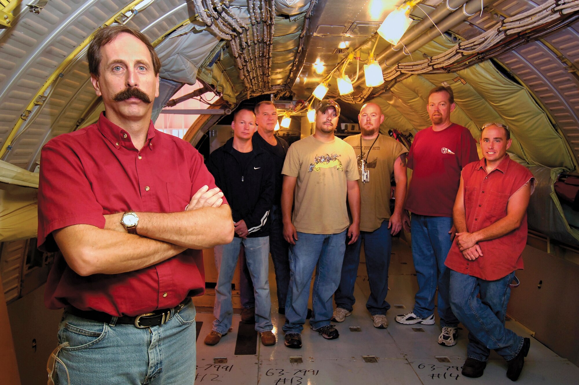 Tinker aircraft planner Brian deFonteny was part of a team who changed the KC-135 cabin pressure testing process, carving days off the flow time and saving the Air Force millions.  Mr. deFonteny stands inside a -135 with mechanics who benefit from the new system.  Back from left are; Darrell McElwee, Clarence Stallard, Josh Massey, Grant Simms, Chuck Drake, and Shane Spencer, who was on the planning team. (Air Force photo by Dave Faytinger)
