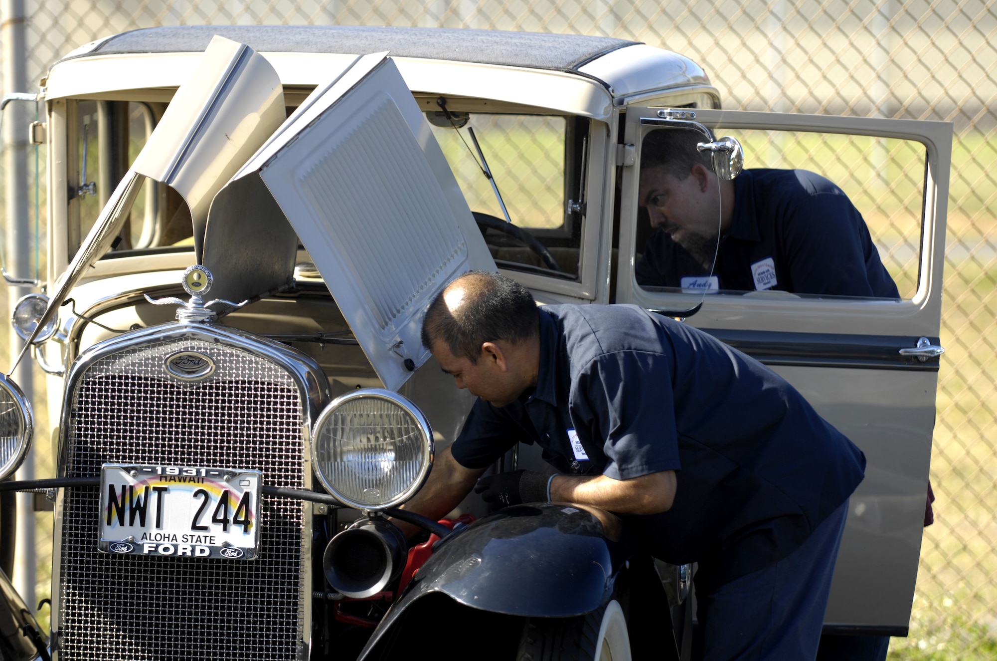 Jason Nakama and Andy Martin work on a car at the Auto Skills Center on Hickam Air Force Base, Hawaii June 6. The Hickam Auto Skills Center was recently awarded the Blue Seal of Excellence from the National Institute for Automotive Service Excellence. The Blue Seal of Excellence recognition program’s emphasis is to identify establishments with a large percentage of ASE certified professionals and businesses striving to be the best and willing to prove their commitment to excellence. Jason is a mechanic and Andy is the manager at the Auto Skills Center. (USAF photo/ Tech. Sgt. Shane A. Cuomo)