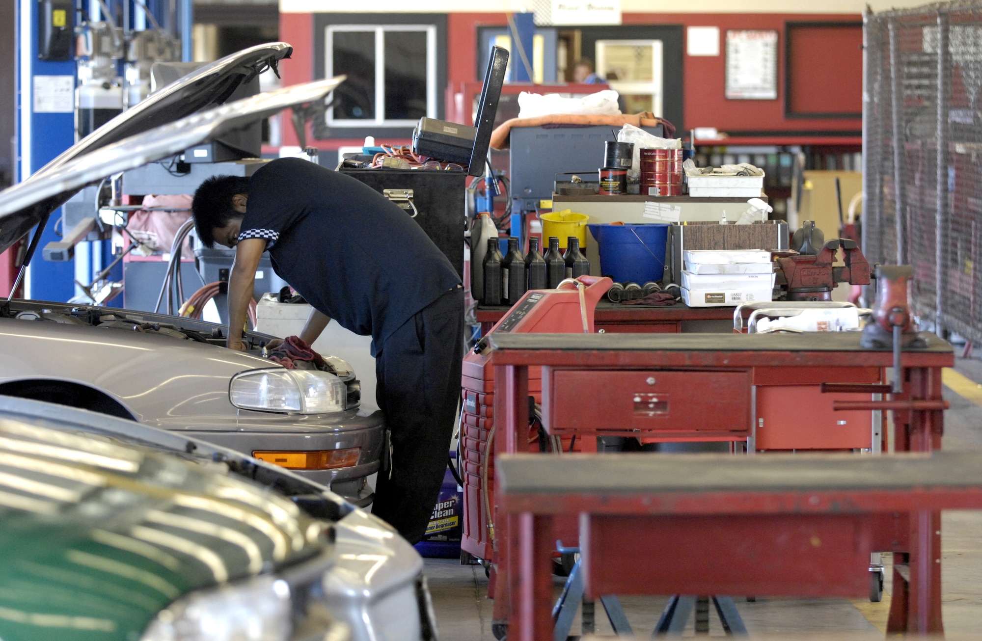 Joe Balancio works on a car at the Auto Skills Center on Hickam Air Force Base, Hawaii June 6. The Hickam Auto Skills Center was recently awarded the Blue Seal of Excellence from the National Institute for Automotive Service Excellence. The Blue Seal of Excellence recognition program’s emphasis is to identify establishments with a large percentage of ASE certified professionals and businesses striving to be the best and willing to prove their commitment to excellence. Joe is an Auto Skills Center mechanic. (USAF photo/ Tech. Sgt. Shane A. Cuomo)
