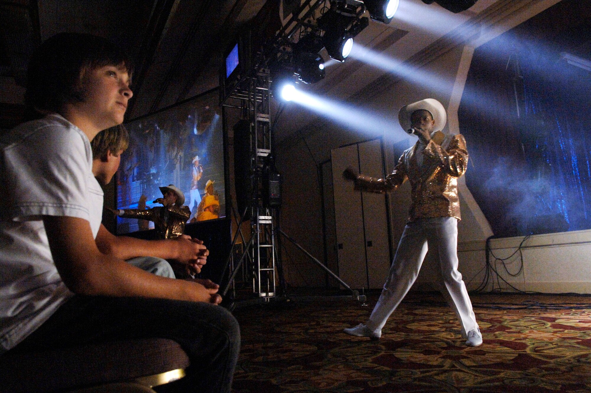 Lucas Conn, 11, watches Airmen from Tops in Blue perform as part of Air Force Week June 5 at the Radisson Hotel in Sacramento, Calif. Tops in Blue is the Air Force's premier entertainment group that performs for audiences around the globe. (U.S. Air Force photo/Tech. Sgt. Larry A. Simmons)
