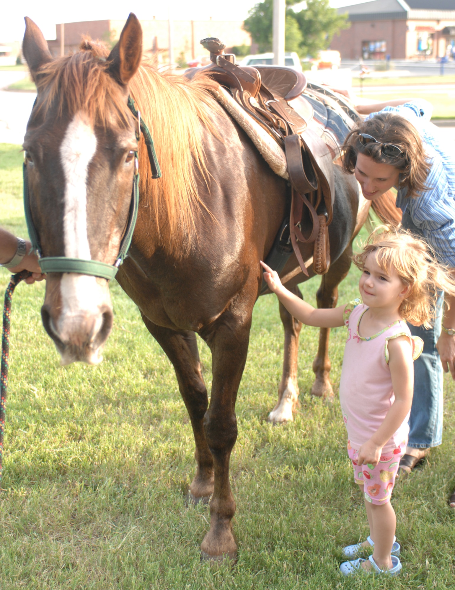 DYESS AIR FORCE BASE, Texas -- Jozsa Incorvaia and Chaplain (Capt.) Marianne Kehoe pet "Ram Rod" the horse during an activity at Vacation Bible School June 6. VBS is one week long, and every day the children learn a new lesson. (U.S. Air Force photo/Airman 1st Class Jennifer Romig)