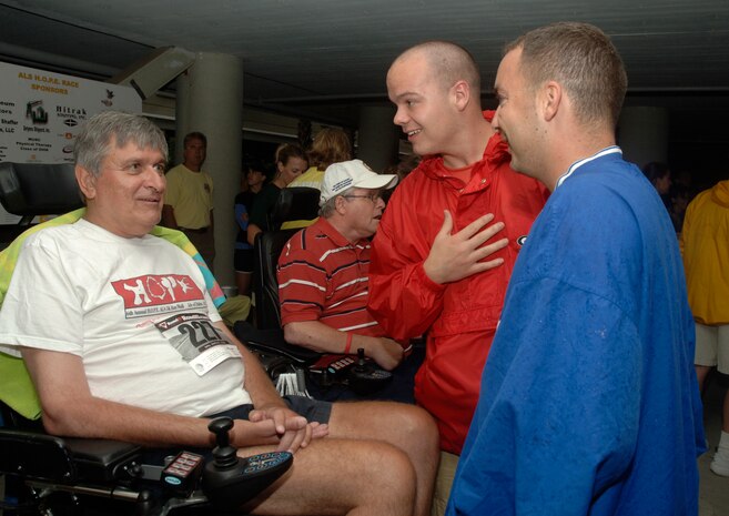 Virgil Smith (red) and Daniel Weil (blue), Airmen Leadership School students, stop and talk to retired Brig. Gen. Thomas Mikolajcik, former 437th Airlift Wing commander, before the run to raise money for Amyotrophic Lateral Sclerosis. General Mikolajcik is currently battling ALS. (U.S. Air Force photo/ Staff Sgt. April Quintanilla)