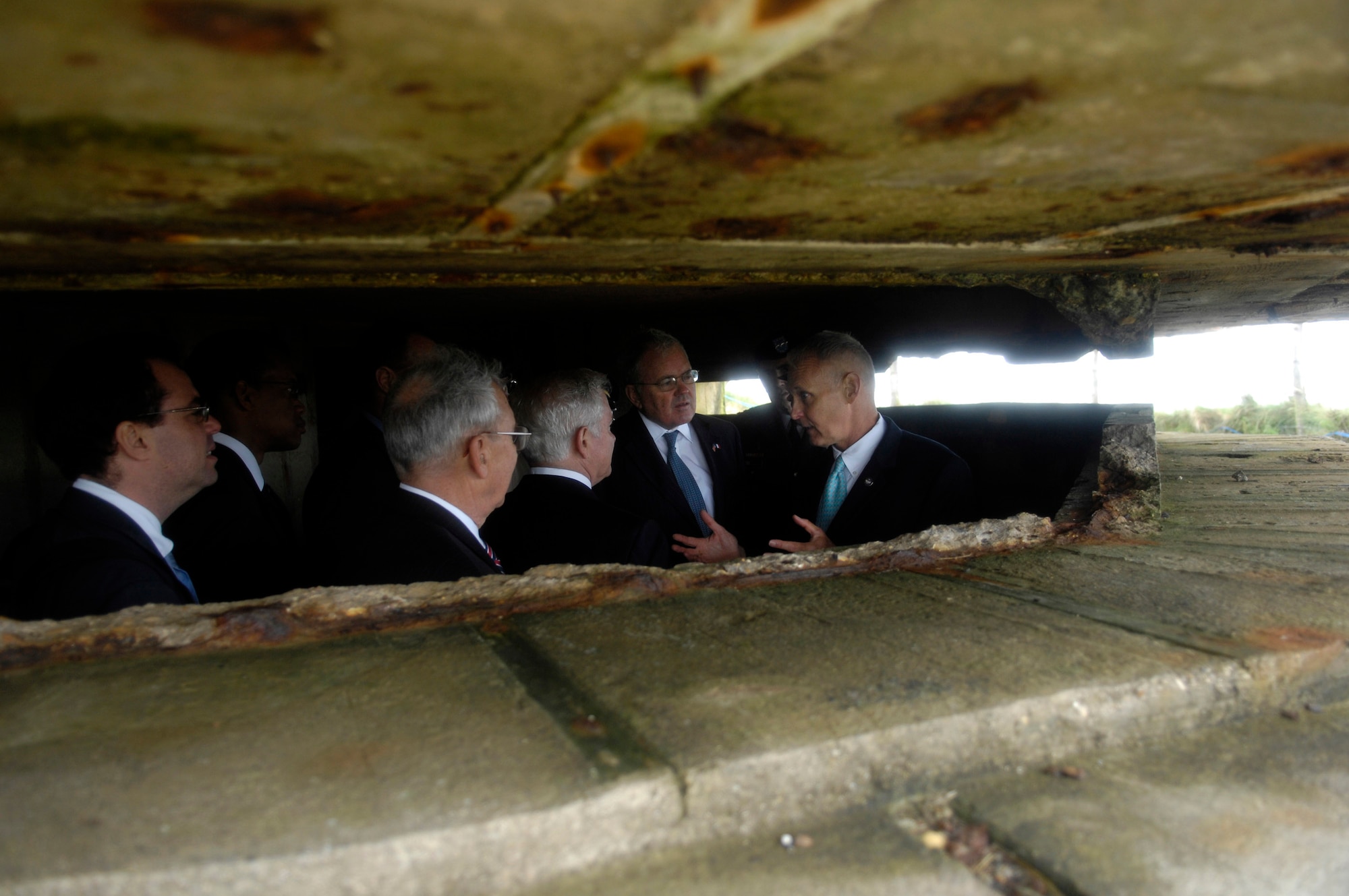 Secretary of Defense Robert M. Gates tours a German bunker at Point-du-Hoc on the 63rd Anniversary of D-Day June 6 in Normandy, France. During World War II, rangers assulted the beaches at Point-du-Hoc and scaled the 100-meter-high cliffs to defeat the enemy for the cause of freedom. (Defense Department photo/Cherie A. Thurlby) 