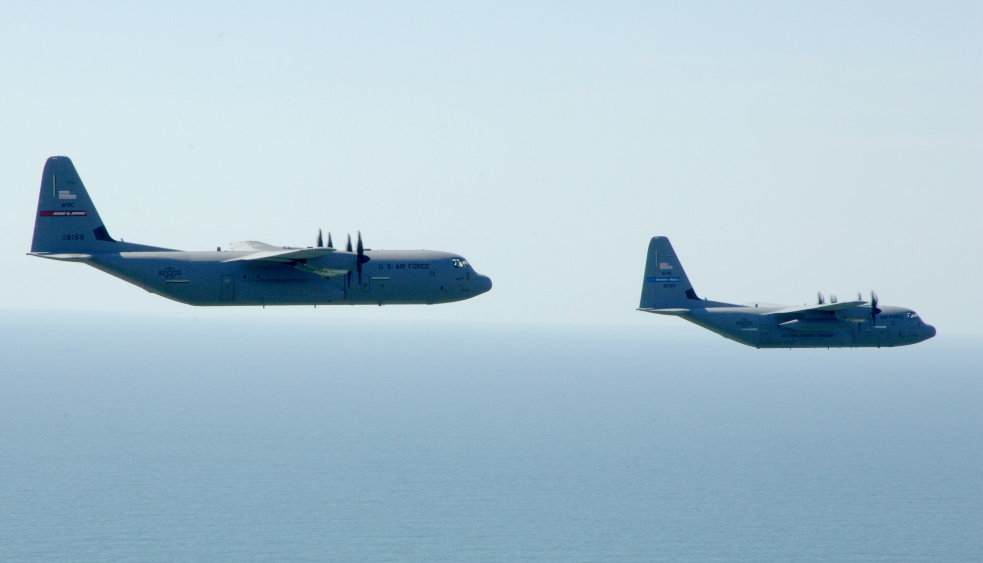 Flying over the Mississippi Sound, a C-130J-30 trails a WC-130J in formation flight. Both aircraft are assigned to the 403rd Wing. The C-130J-30 is used for all manner of airlift and is assigned to the 815th Airlift Squadron while the primary mission for the WC-130J, assigned to the 53rd Weather Reconnaissance Squadron,  is hurricane reconnaissance. (U.S. Air Force Photo/Tech.Sgt. James B. Pritchett)
