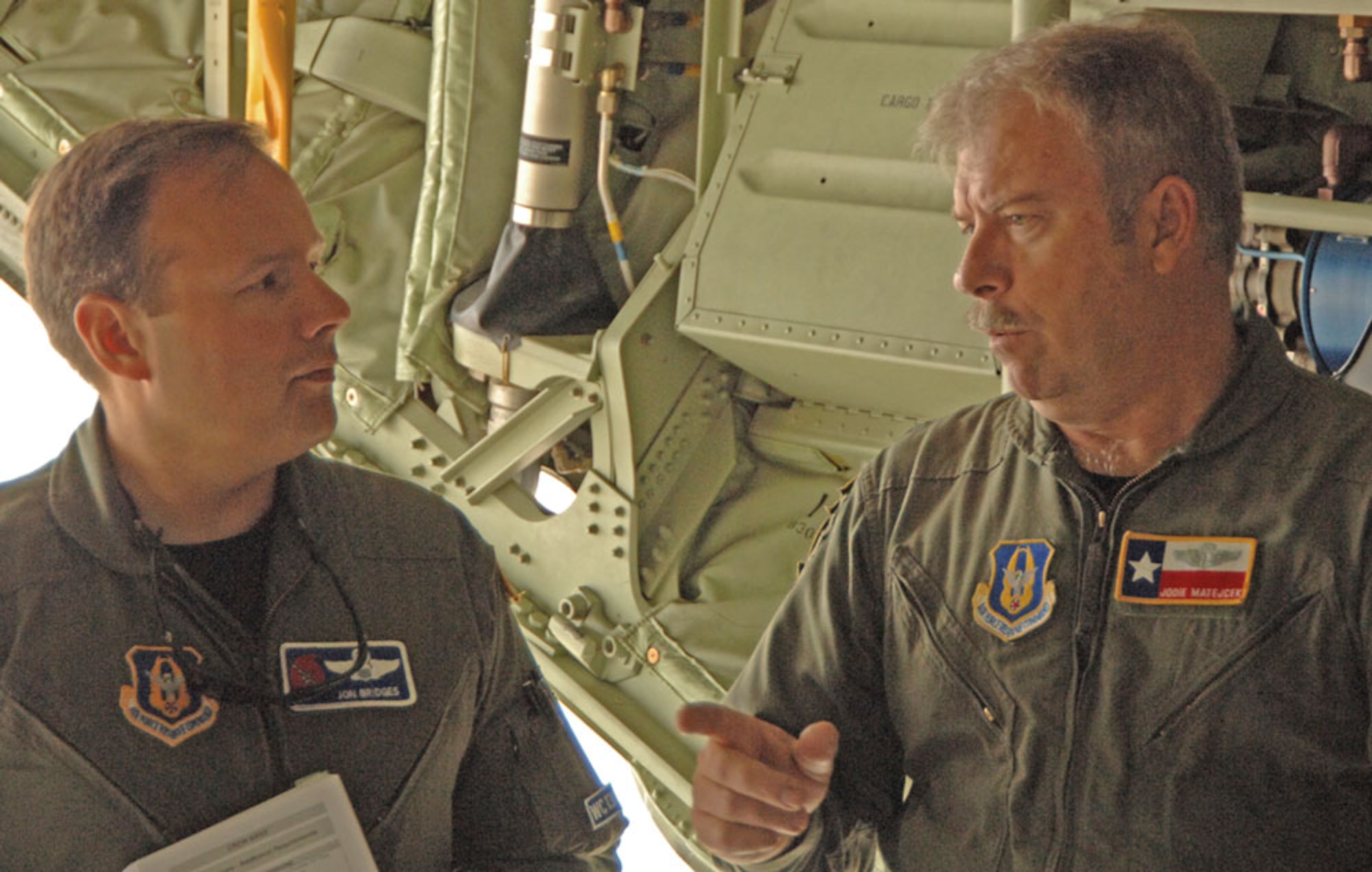 Maj. Jon Bridges, aircraft commander (left), 53rd WRS, discusses the training scenario with Lt. Col. Jodie Matejcek, officer in charge, 433rd AES before takeoff during an aeromedical evauation mission. (U.S. Air Force Photo/Tech. Sgt. James B. Pritchett)