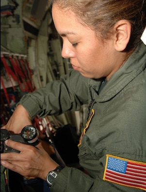 Tech. Sgt. Lisa Perales fills containers with Liquid Oxygen called LOX from a port on a WC-130J aircraft. (U.S. Air Force Photo/Tech. Sgt. James B. Pritchett)