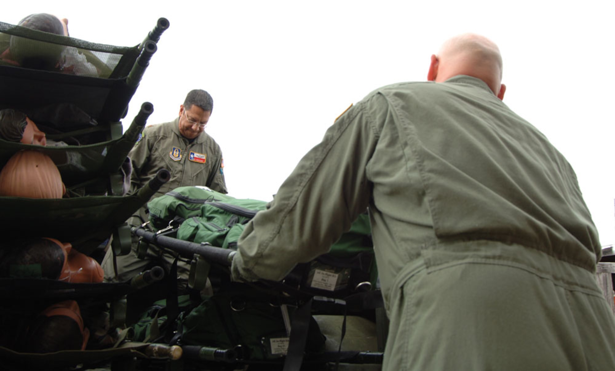 Tech. Sgt. Mark Juarez and Maj. Gerry Martinez load litters onto a truck for transport to a WC-130J flown by the 53rd Weather Reconnaissance Squadron. (U.S. Air Force Photo/Tech. Sgt. James B. Pritchett)