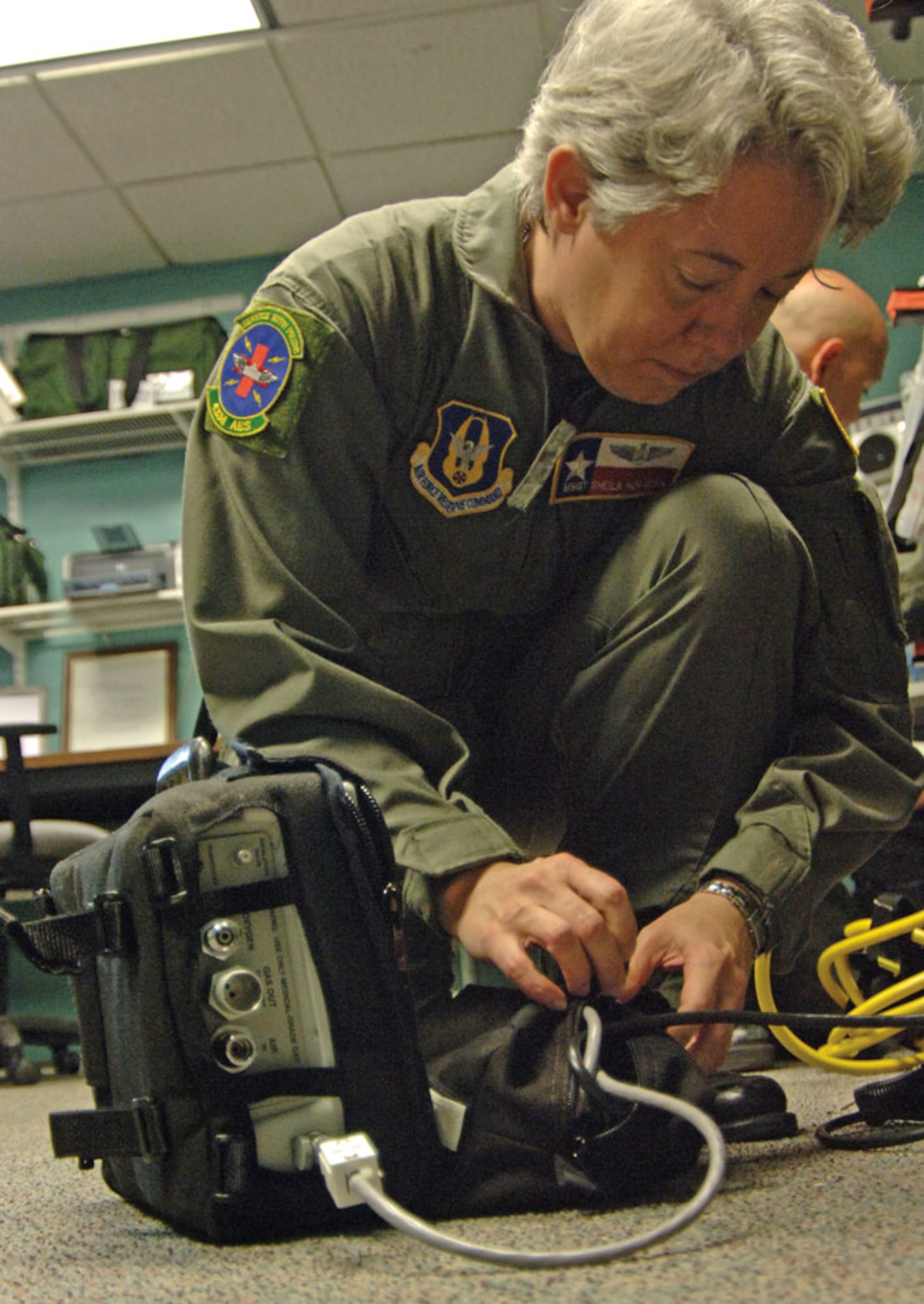 Master Sgt. Sheila Hoglan, performs pre-flight checks on electronic medical gear. (U.S. Air Force Photo/Tech. Sgt. James B. Pritchett)