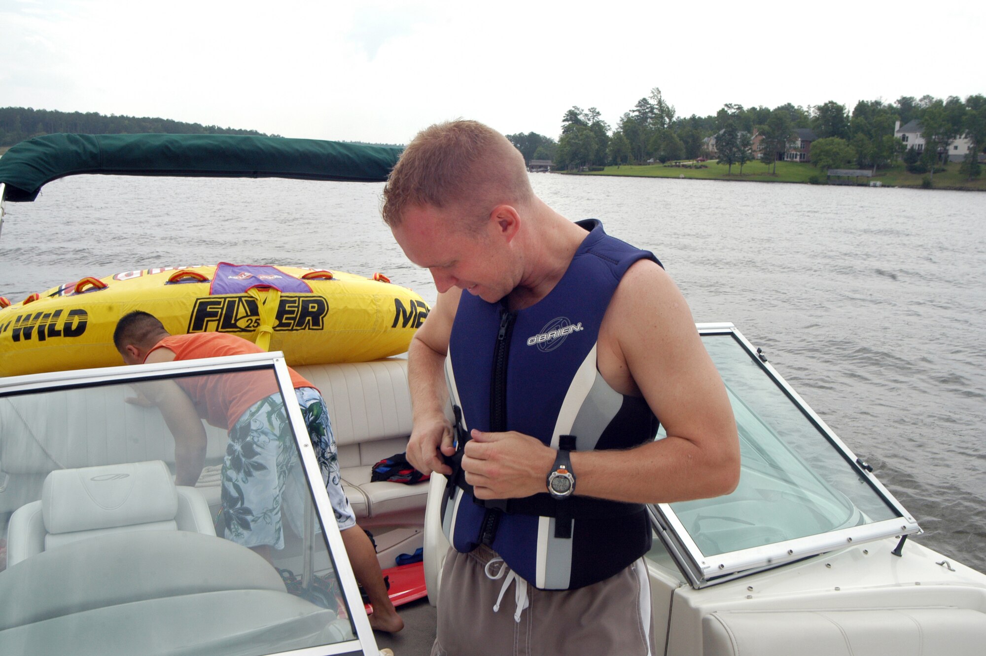 1st. Lt. Jason Knab fastens on a life vest before boating on Lake Tobesofkee. U. S. Air Force photo by Sue Sapp 